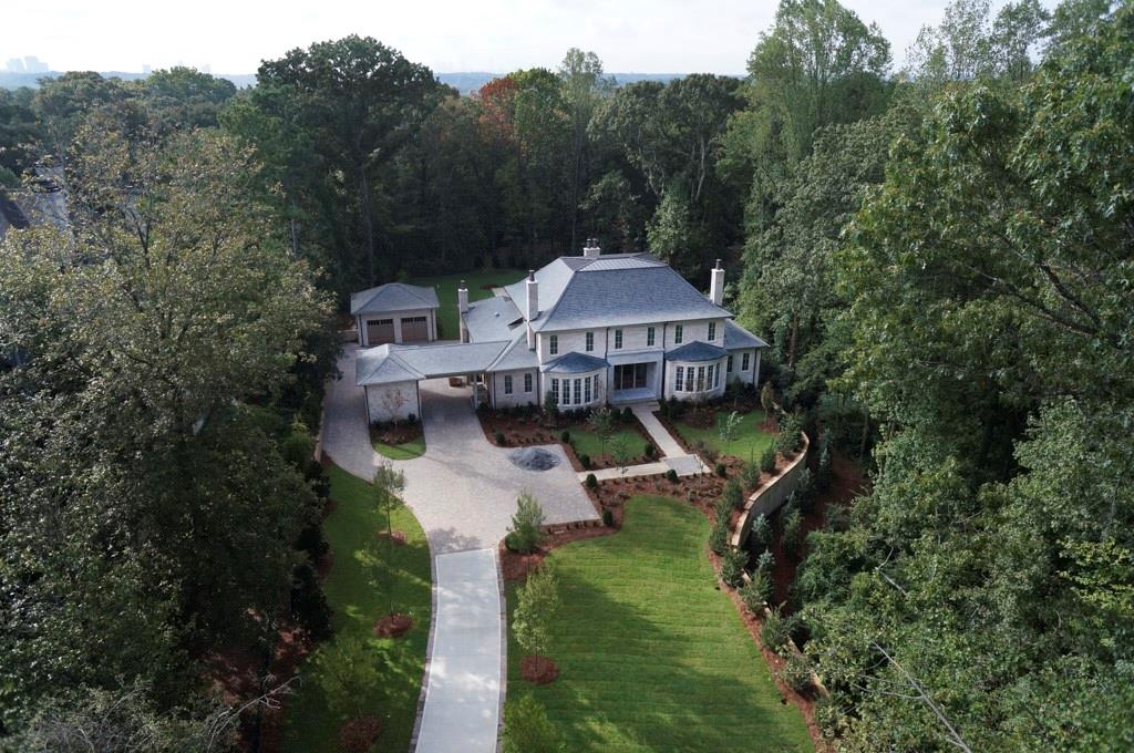 Situated on almost 2 acres this gated estate has the best of everything! Built like a custom home with slate roof, amazing master suite on main with marble bath, gourmet light filled kitchen and keeping room. This floor plan works well with living room and keeping room opening to fabulous covered porch with fireplace and beautiful gardens and pool! Newer construction you don’t want to miss this one!