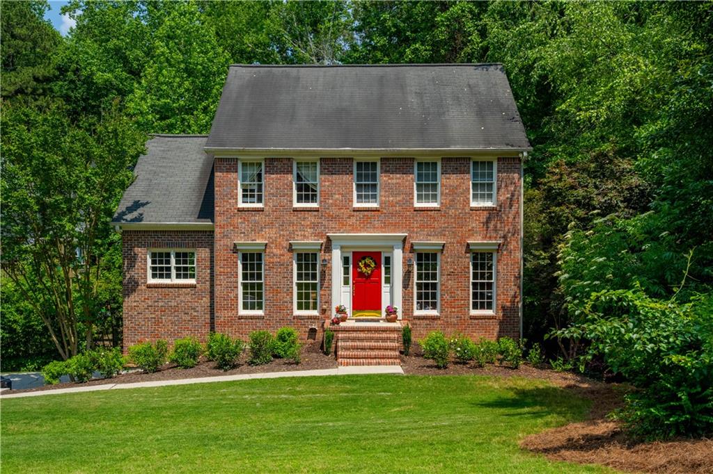Sought after a brick Colonial home with the CUTEST backyard! Set back on a large lush lot with flowering shrubs and plants, the home exudes curb appeal. Inside the traditional floor plan provides privacy when needed but it offers an easy flow. With the den/office/formal living area at the front as well as the family room and kitchen. Offering granite counters, stainless appliances and plenty of cabinets this kitchen has everything one would need. The adjacent dining room and cozy, fireside family room face the backyard which allows for a lot of natural light to flow through. From here you have access to the large back deck which overlooks the adorable backyard featuring a creek and separate fenced areas to enjoy. Upstairs the spacious Primary bedroom boasts a private en suite bathroom with separate tub and shower along with a double vanity. Two additional guest rooms share a great secondary bathroom. Additional living space can be found in the finished basement area, making this the perfect media room or hang-out space. You will really spend most of your time outside enjoying the views down to the sweet, babeling creek. Take the bridge over to the extended yard where there is plenty of room to garden and just relaxing among the trees. This is really living!