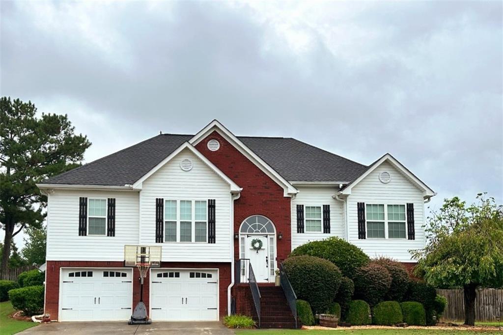 Welcome to timeless farmhouse charm with modern elegance! Nestled on a peaceful street in the sought-after Sonoraville School District, this beautifully maintained home combines classic Southern style with today's most desirable features. From the inviting front yard to the covered back porch, every detail radiates comfort and sophistication. Step inside to discover an open-concept living space with shiplap accents, and abundant natural light. The exquisite kitchen features solid surface countertops, stainless steel appliances, a farmhouse sink, and formal dining perfect for entertaining. The finished lower level offers a spacious second living area, private bedroom, and full bath perfect for a she shed', man cave', teens, guests, or multi-generational living. With its thoughtful layout, designer touches, and a location minutes from schools, restaurants, outlet shopping, and I-75, this home blends farmhouse elegance with everyday functionality. Schedule your showing today!!