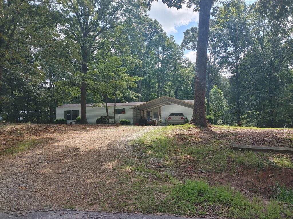 Nice single wide 2 bedroom/2 bath home with 1.2 acres. No HOA, Tenant in place on month to month lease, out by end of September. Title has been retired. Detached carport, front porch and back deck. Level lot perfect for building with nice hardwoods. No FHA, VA or USDA. Selling "As Is".