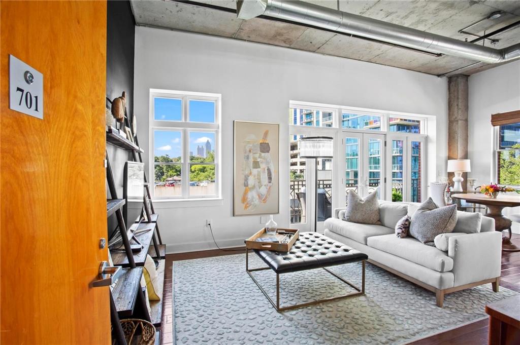 Amazing opportunity to lease a large, penthouse level unit in a posh loft building! Ditch the loud and rowdy apartment life and come join this tight-knit community in one of Midtown's favorite boutique buildings. Corner unit boasting insane natural light and gorgeous wrap-around views of city life. Soaring 11 foot ceilings provide a dramatic impression from the jump. Hardwood floors connect each space in this special home, seamlessly flowing from living room to dining space. The gourmet kitchen will impress any at-home chef (or DoorDash expert, we don't judge) with it's designer finishes, SS appliances, and ample countertop space, including the sleek industrial island. The primary suite is a true retreat tucked at the back of the home and features a large walk-in close with a conveniently located washer and dryer. Dripping in marble, the en-suite bathroom looks straight out of a magazine with it's sizable custom shower and dual vanity setup. Like having the Four Seasons spa at home! Uber quiet building made better by having no above you and only one shared wall with a friendly neighbor. One assigned parking space in the gated garage and ample street parking. This location is truly unparalleled; you're just steps away from iconic Piedmont Park that opens onto the Atlanta Beltline, Midtown nightlife with it's good clean fun, and premier dining and shopping at Colony Square. Hurry hurry, this special opportunity won't last for long!