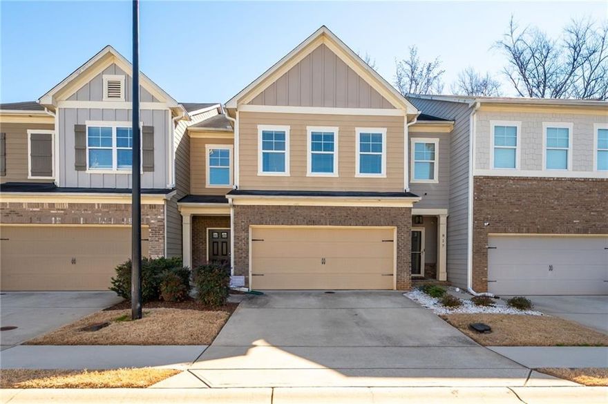 Step into the comfort and style of 813 Whittington Parkway, a beautifully appointed 3-bedroom, 2.5-bathroom townhome in Marietta. This home combines an open-concept design with modern amenities and a touch of nature, creating a perfect setting for relaxation and entertaining. The main level welcomes you with gleaming hardwood floors that extend throughout the open living space. The living room, centered around a striking gas fireplace, provides a warm, inviting atmosphere for gatherings or quiet evenings at home. Adjacent to the living area, the eat-in kitchen features granite countertops, stainless steel gas appliances, and a walk-in pantry. The kitchen opens to a charming deck with privacy siding, offering serene backyard views. A convenient half bath on the main floor adds functionality. Upstairs, the spacious primary bedroom serves as a private retreat, complete with a sitting area, stylish accent wall, and tray ceiling. The large walk-in closet provides ample storage, while the ensuite bathroom boasts a double vanity, separate shower, and bathtub. The home's bathrooms were updated with new vanities and fixtures last year. Two additional large bedrooms feature spacious closets and share a well-appointed full bathroom. The laundry room, conveniently located upstairs, ensures easy access. This townhome also includes a two-car garage, providing plenty of space for vehicles and additional storage. Located close to local amenities, 813 Whittington Parkway offers a blend of modern living and a convenient location, making it an ideal choice for anyone looking to live in Marietta.