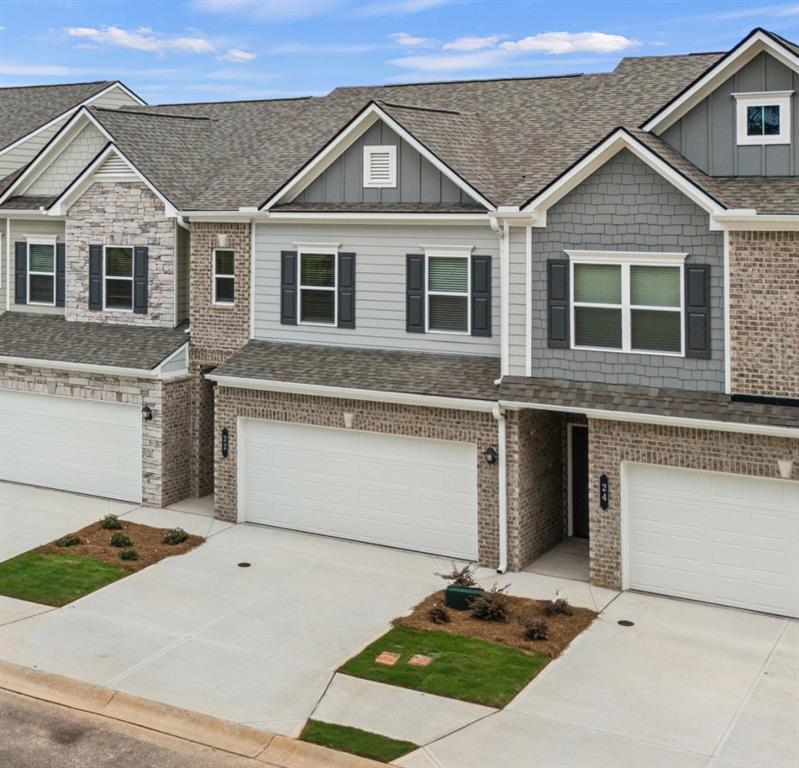 Move in Ready! The Norwood II, a thoughtfully designed floorplan located in Smith Douglas Homes Franklin Manor community. This beautifully crafted residence offers the perfect balance of modern design and low maintenance living. Step inside to discover an open-concept layout that seamlessly connects the kitchen, dining and family room- ideal for everyday living and effortless entertaining. The family room opens to a deck for outdoor entertaining. A sleek linear fireplace adds warmth and a stylish focal point to the main level. Upscale features include updgraded cabinetry, vinyl plank floors on the main level, Quartz counters in the kitchen, and stainless appliances. Upstairs includes two secondary bedrooms, a spacious loft that provides a flexible bonus area, along with a convenient laundry room. A private primary suite featuring a tray ceiling, generous walk-in closet and a spa like bath with a tiled shower and double vanity. Nine foot ceiling heights on both levels. Lawn maintenance is included in your HOA giving you more time to enjoy your new lifestyle! Primary photo of home secondary photos representative of plan not of actual home. Seller incentives with use of preferred lender.