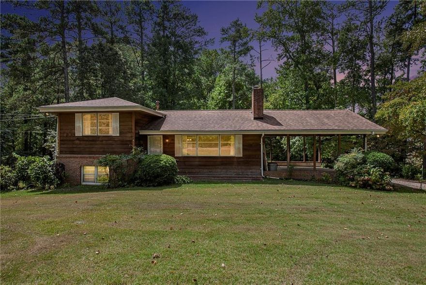 This home features a WORLD of possibility! Located in a very sought-after part of Marietta, this home is situated on 2.5 Acres which could be rezoned into gorgeous commercial or mixed-use property. This could also just be a home you call your own, with a little TLC and some updating this beauty with the land could easily be very equity-rich. Home has two kitchens and two living spaces with 4 bedrooms and two baths. The home is set up with a roommate floor plan in mind, there is so much that you could do with the abundance of space. The Land is flat and extremely useable. Come and see it today, let your imagination take over.