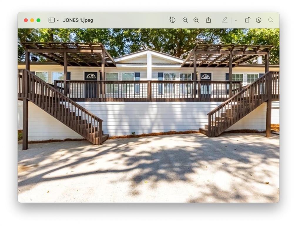 Back of property featuring stairs and a pergola