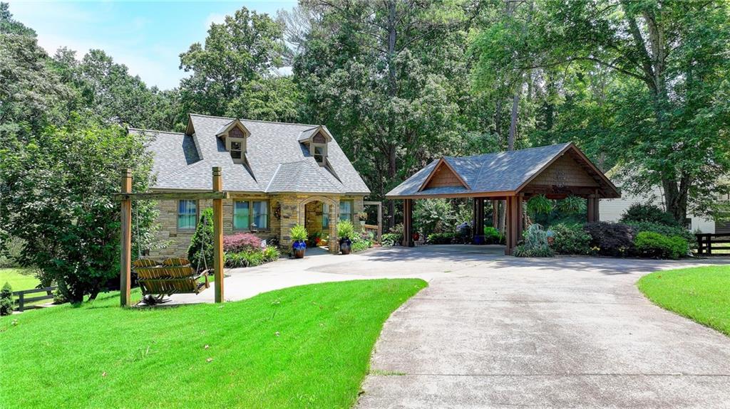 MOVE-IN READY IN MILTON! Craftsman style 5 bedroom, 3 full bathroom home on a FINISHED BASEMENT. The stone front entrance welcomes you to the open concept family room, dining room, and chef's kitchen. The stone covered kitchen island gives you plenty of room and looks over the family room. Includes stainless steel appliances, plenty of storage cabinets, and a walk-in pantry. The spacious MASTER ON THE MAIN suite has a wall of windows overlooking the private, wooded backyard. The spa-like master bathroom has been completely updated with beautifully tiled floors, double vanities, soaking tub, separate shower, and walk-in closet. The huge loft/bedroom upstairs makes for a great studio. office, or private retreat with its own full bathroom. Finished basement with large media/entertainment room and plenty of storage. The sweeping 3 year-old deck provides plenty of room for entertaining with views of the lush, flat backyard with extensive landscaping. Updates include a new roof in 2023, HVAC replacement in 2021, a tankless water heater (so you always have hot water), and an encapsulated crawl space with full warranty. Located in the sought after Camridge High School cluster and nearby top-rated private schools including Kings Ridge Christian School. Located in the heart of Milton near great shopping, restaurants, Bell Memorial Park, and with easy access to GA 400.
