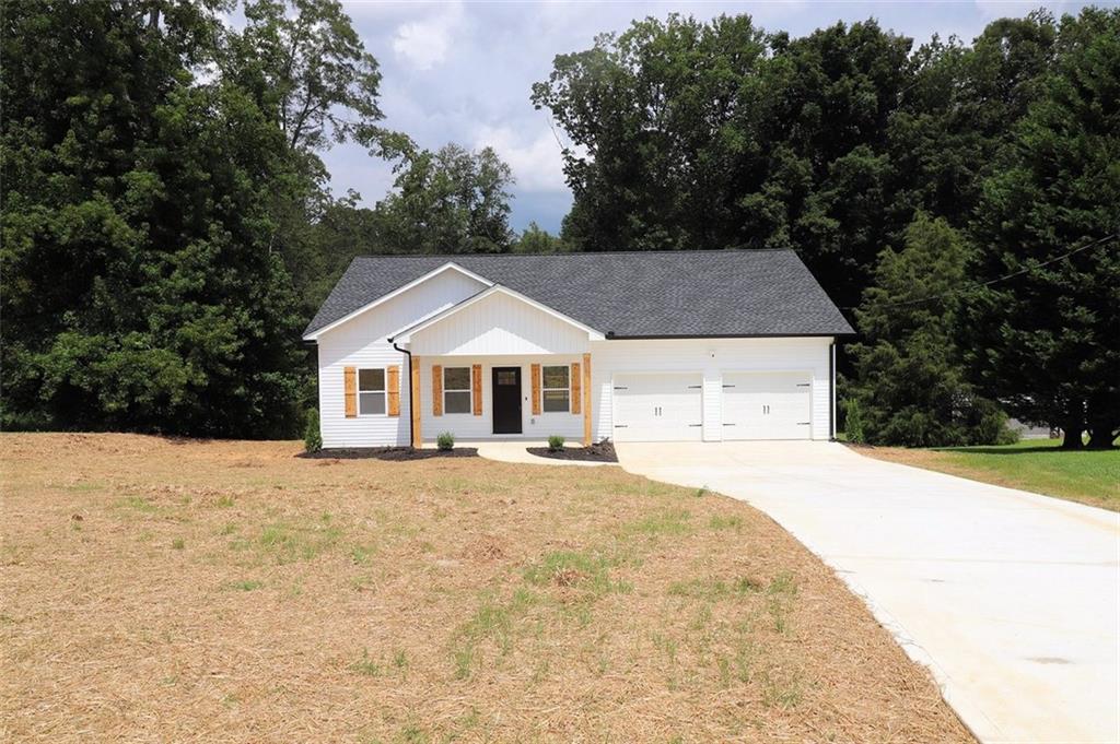 Located 5 minutes south of I-20 Exit 11, this new Ranch Home on a 1.24 acre lot has all the extra details. The best detail is it qualifies for USDA 100% no money down financing! Kitchen features Granite counter tops, ceramic tile back splash, stainless steel appliances, and a large center island. Whirlpool Gold Appliance package includes a French Door refrigerator and Front Load washer and dryer. Primary Bedroom features a large walk-in closet with 2 rows of shelves. Both bathrooms feature real ceramic tile showers, glass block privacy windows, and high efficiency toilets. Remote control ceiling fans/lights are in the living room and three bedrooms. Huge attic includes pull-down attic stairs and extra plywood flooring for storage. 2 car garage features windows, shop lights and Wi-Fi auto garage door openers. A big 12x16 deck looks over the peaceful back yard. Ring cameras are actively watching the exterior for security. AT&T Fiber internet is installed and active. All electric home. Heat Pump. 50 gallon water heater. 1445 sq ft heated living space plus a 302 sq ft garage. This beautiful new home includes a 1 year Builder warranty.