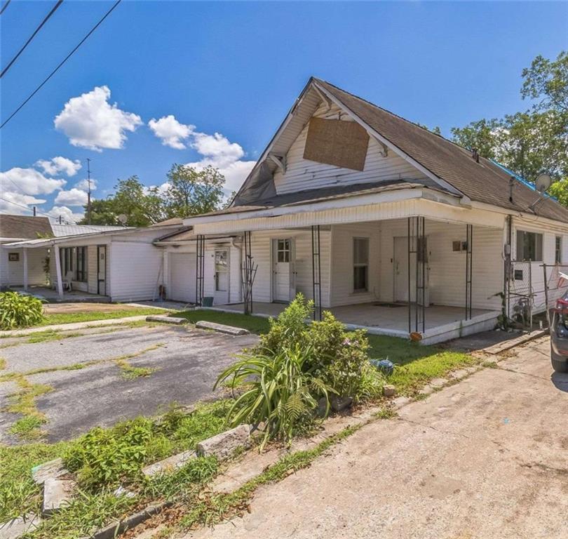 Investor's dream in Thomaston! This duplex at 221-223 Avenue L (Legal Description is 221 Avenue L) offers 5 bedrooms, 3 bathrooms, and 2,690 square feet with tremendous fix-and-flip potential. Both units need full renovation, making this the ideal project for buyers looking to add value and maximize returns. Unit 221 features 3 bedrooms, 2 bathrooms, and a one-car garage. Unit 223, previously used as a storefront, includes 2 bedrooms and 1 bathroom and can be restored as a residential unit or reimagined as a live-work or commercial space. In addition to the garage, the property provides five outdoor parking spaces-an uncommon feature that complements its mixed-use potential. The spacious backyard includes an in-ground swimming pool ready to be revitalized as a standout amenity. Please note: the laundry room sustained fire damage and will require repair as part of the renovation. Priced at just $80,000, this property sits well below area averages, where homes in the 30286 district sell near $200,000 with strong growth. Renovated duplexes in the Thomaston market can command resale values in the $345,000-$399,000 range, and rental demand supports strong long-term income potential, with area rents averaging $1,400 per unit monthly. With limited duplex inventory available, this property presents a rare opportunity to create significant value whether you hold as a rental, resell after renovations, or reimagine both units for maximum ROI.
