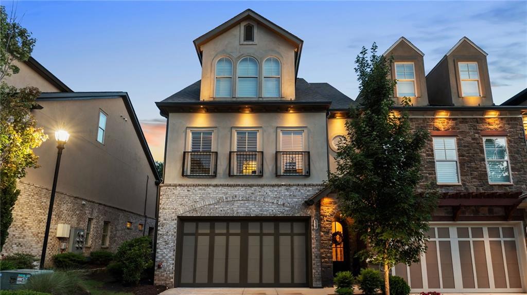 Welcome to the most beautiful end unit townhome with a Hydraulic elevator and the highest end luxury finishes throughout the residence in this amazing gated community, Tuscany Village. One of the original floor plans, the Cortona features 3,400 square feet with bullnosed walls, barrel archways, curved staircases and so much more. As you walk through the front door you will fall in love with the arched front door, archway and details that lead you into your new home. The Kitchen is sure to impress with the unique two-story ceiling, 42" full overlay Shaker cabinetry, new custom countertops, Stainless Steel hood with tile to the ceiling, large island, Stainless Steel appliances, gas cooktop and new faucet. The open view to the Dining Room with remote controlled shades and transom windows provide amazing light to your private landscaped backyard. The Great Room is perfect with a coffered ceiling, gas fireplace and large bi-fold sliders that open to the expanded patio. This enlarged curved patio features beautiful landscaping, a remote-controlled privacy shade from the covered sitting area and is the perfect place to grill out all summer or have a relaxing afternoon. The elevator, or curved staircase, leads to the second floor that features a spacious owner's suite with a gas fireplace, gorgeous circular tray ceiling, wall trim details and two separate walk-in closets. The owner's bath will be the perfect place to relax with a free-standing tub, walk-in tile shower and two separate vanities with custom countertops and new lighted mirrors. The two secondary bedrooms on this floor share a beautiful hall bath with walk-in shower. The laundry room is conveniently located in the hallway with a large sink and cabinetry. Upstairs on the third floor you will fall in love with the large entertainment space that includes an additional fireplace, half bath and upgraded French doors that lead to the expansive rooftop deck with private wooded views. The top floor lounge offers luxury and privacy with the rooftop space like no other. The upgraded railings were just added and if you want a second kitchen, the plumbing are already in the lounge area. The third floor also includes an oversize bedroom with sitting area, walk-in closet and ensuite bath. The elevator is easily accessible to all three floors. The upgraded light fixtures, new countertops, new mirrors, new faucets, remote controlled shades, plantation shutters and new open metal railings on the rooftop deck are a few of the latest touches you will enjoy. You will fall in love with the distinctive details in this property. You won't want to miss out on 117 Via Roma near downtown Woodstock. You can enjoy walking out of the front community gate and walking or biking to all that downtown Woodstock has to offer. Also conveniently located near grocery stores, restaurants, shopping and Highway 92, you can easily access heading into Atlanta or heading north to the Georgia Mountains anytime. Welcome home!