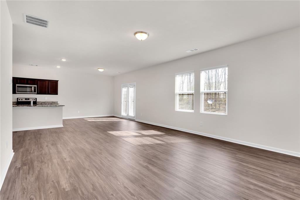 This beautifully renovated Single Family home in Northwest Forsyth Count offers 4 bedrooms and 2.5 baths. The interior walls have been freshly painted and the first floor has been fitted with new LVP flooring throughout. The open concept living area with a family room that opens up to the kitchen and dining area provides the perfect space for entertaining, and it extends onto a back deck overlooking a wooded area and the tranquil Settendown Creek. The kitchen boasts granite countertops, a large breakfast bar, and stainless steel appliances, while a powder room on the main floor is a convenient feature for guests. The main floor also includes an office/playroom, adding versatility to the living space.
Upstairs, you'll find a master suite with an ample-sized bath and a large walk-in closet, as well as three additional bedrooms and a full bath. There's also a loft area that can be used as a play area, office, or TV area. The property is conveniently located just minutes away from shopping and restaurants in both Cumming and Dawsonville, making it the perfect home for those who want to enjoy the best of both worlds. This home is an exceptional choice for anyone looking for a beautifully renovated space with plenty of room for comfortable living and entertaining.