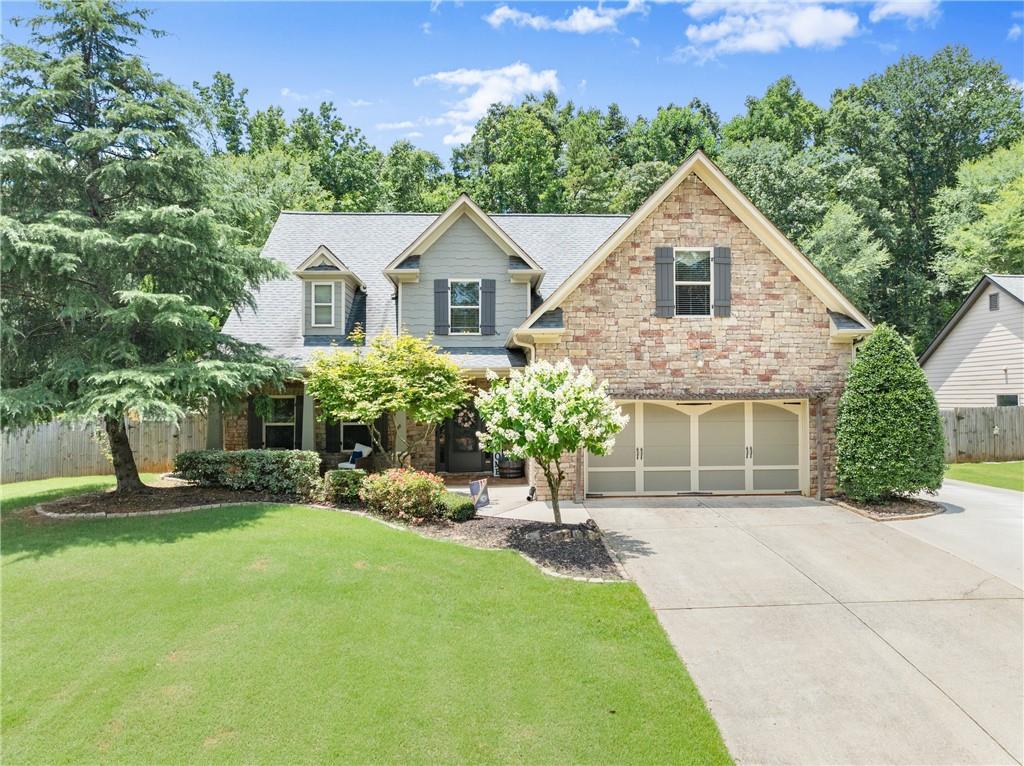 Gorgeous two-story home on a beautifully manicured 0.60-acre lot in sought-after Lake Vista Estates! Enjoy sunny days by the pool and relaxing evenings in the hot tub. This immaculate, model-perfect home features 4 spacious bedrooms, 3 full baths, a powder room, and a dramatic two-story foyer. The open floor plan offers the perfect blend of comfort and space, showcasing gleaming hardwood floors, elegant arched openings, and a formal dining room that flows into the bright kitchen with white cabinetry, granite counters, double ovens, stainless steel appliances, a breakfast bar, and butler’s pantry. The vaulted great room centers around a cozy fireplace, while the main-level oversized primary suite impresses with a tray ceiling, double vanities, a custom walk-in closet, and spacious bath. Upstairs includes three additional bedrooms and two full baths—perfect for guests, home offices, or flexible living space. Outdoor living is a highlight with a hot tub, above-ground pool, three-tier deck, and covered patio—ideal for entertaining or relaxing. The fenced yard includes a dog run/kennel and storage building. A two-car garage and extended driveway provide ample parking for 4+ vehicles. Walk to the community lake with kayaking, fishing, pavilion, playground, and playfield. Conveniently located near I-85, Athens, shopping, and dining.