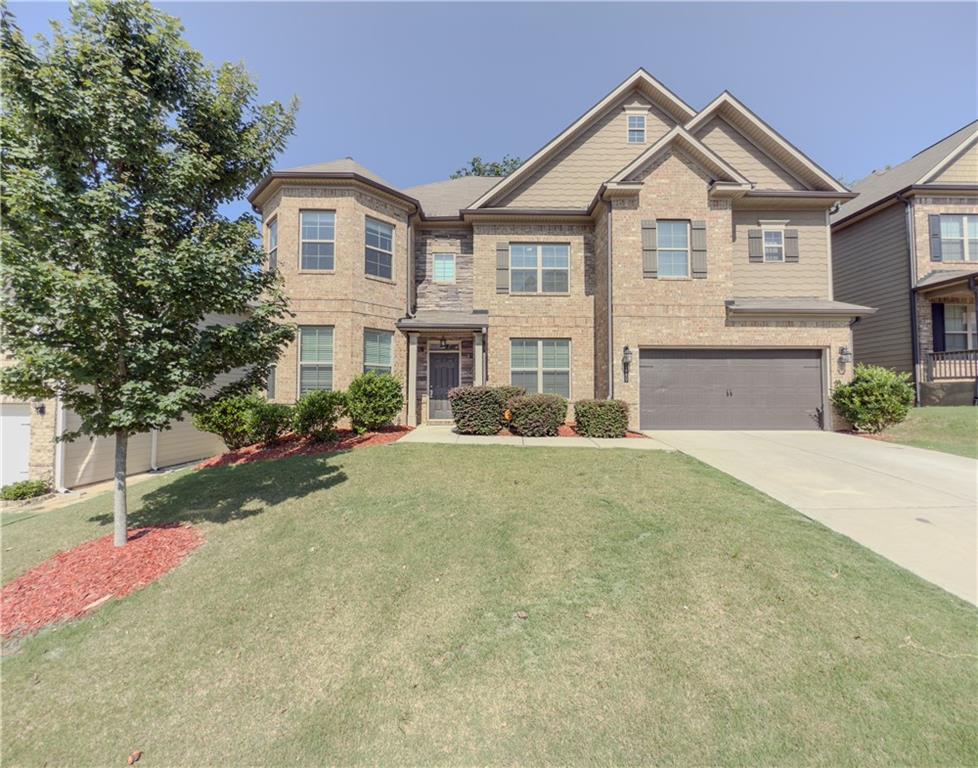 Awesome looking Brick Front home w. Double Bay Turrets & Large Covered Rear Back Patio in sought after Mill Creek School district! Reynolds plan has 6 bedrooms & 4 Full Baths! Guest bedroom & full bath downstairs. Master Bath has Tile Shower and Tiled Drop-in Tub! Hardwood floors 1st floor main areas! Gourmet Kitchen w. Espresso cabinets / stainless steel appliances w. double ovens & side-by-side refrigerator. Olympic sized swimming pool & clubhouse. Only 1 mile from Interstate I-85. GOOD RENTAL HISTORY- 2 RENTAL REFERENCES-AND CREDIT CHECK IS REQUIRED