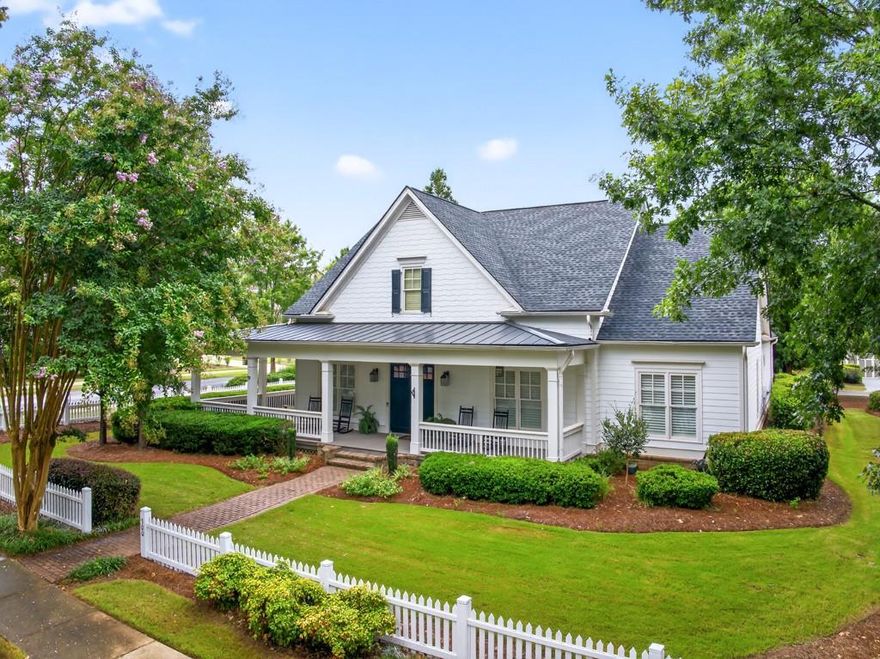 Welcome to this luxuriously upgraded 5-bedroom, 4-bathroom home in the highly sought-after Georgia Club, a gated golf course community known for its Southern charm and resort-style amenities. Situated on a premium corner lot, this beautifully maintained home features a white picket fence, a charming wraparound front porch, and a rear-entry garage, all adding to its curb appeal. Inside, enjoy new flooring, fresh interior and exterior paint, and thoughtful architectural details throughout. The spacious living room features a coffered ceiling, creating a sophisticated and inviting space for gatherings. The kitchen is accented with brick details, blending rustic warmth with modern utility. Perfect for remote work or study, the private office includes custom-built-in shelving. The oversized primary suite is a true retreat, featuring two large custom walk-in closets and a spa-inspired en suite bathroom with a large walk-in shower, double vanities, and elegant finishes. Enjoy year-round efficiency with a solar energy system and keep your landscaping lush with the automated sprinkler system. Located in The Georgia Club, residents have access to world-class amenities: golf, pools, tennis courts, clubhouse, fitness center, and walking trails. This home offers a rare combination of classic Southern charm and modern luxury in one of Georgia's most desirable communities. Seller is offering Buyer a 2-1 Rate Buy Down with acceptable offer. Reach out to Joshua Egnoski to find out how much you can save per month with this fantastic program!