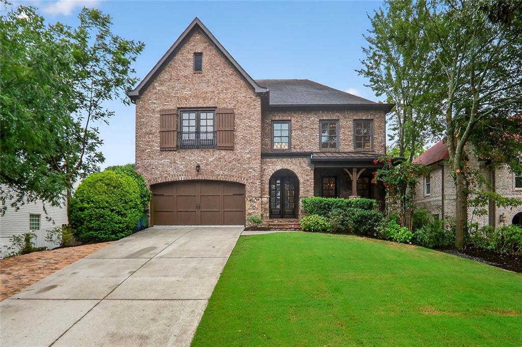 Classic style blends with modern functionality in this brick and stone home in Ashford Park situated walking distance to Georgian Hills Park and the trails of Skyland Preserve. Charming front porch, welcoming two-story foyer and an open floor plan designed for everyday living and entertaining. The renovated kitchen is the heart of the home, featuring custom inset cabinetry, quartz countertops, stainless steel appliances including both a dishwasher and sub zero refrigerator with cabinet matching panel, and great counter seating. It flows seamlessly into a bright breakfast area, a cozy keeping room with upgraded lighting and trim, and a fireside living room with built-ins and recessed lighting. Step outside to a screened porch, perfect for cool nights by the fire, that overlooks a large, flat, walk-out backyard with beautiful sod, irrigation and privacy. An additional open-air deck makes grilling a breeze. The main level also includes a separate office nook, mudroom entry from the garage, and a full guest suite. Upstairs, the expansive owner’s suite offers a sitting room, coffered ceilings, custom closets, and a luxurious bath with a multi-head walk-in shower, soaking tub, double vanity, and tons of built-in storage. A second, private laundry room can be a functional upgrade or considerable additional closet space. Three additional bedrooms each with a full bath, and a laundry room off the upper hall with counter, cabinets and a wash sink. The finished basement is a true showstopper with a game/media room, bar/kitchenette, full bath, and three versatile rooms for a gym, guest space, hobbies, or more. A rare opportunity to own a well-appointed home in one of Brookhaven’s most sought-after neighborhoods.