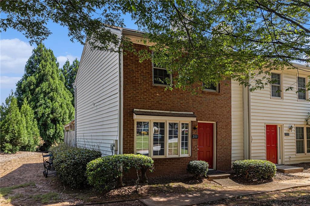 Updated, move-in ready end-unit 2BR/2.5BA townhome, conveniently located near Exit 7 of GA-400 and Downtown Roswell. The main level offers a spacious fireside family room combined with a dining area. The renovated kitchen opens to the dining and family rooms and features brand-new cabinets, stainless steel appliances, and stone countertops. A half bath with a laundry closet and a private two-vehicle covered carport complete the main level. Upstairs are two generously sized bedrooms with walk-in closets. Each bedroom has its own private bathroom, both updated with new vanities and fixtures. Additional updates include fresh paint, new flooring, updated light fixtures throughout, and a newer HVAC (2023). Enjoy close proximity to North Point Mall, Big Creek Park, Canton Street, and Avalon—all less than five miles away—offering endless options for shopping, dining, outdoor activities, and nightlife. The Holcomb Crossing community is beautifully maintained, with a low HOA of just $225 per month, which covers roof replacement, grounds maintenance, and access to a sparkling pool. Best of all, the community has no rental restrictions.
