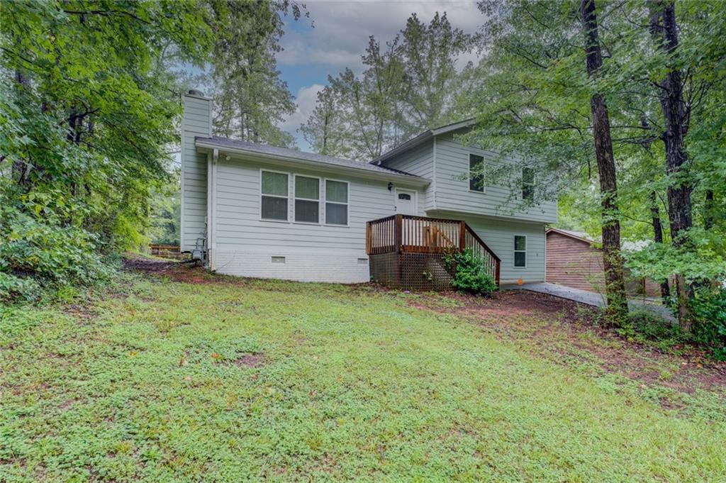 Gorgeous & SO Much Space! Move in Ready Split level w/ 5 bedrooms & 3 Full Baths! Open family room w fireplace & vaulted ceilings flows into kitchen with Huge island/breakfast bar and granite counters. Owners bedroom & Tiled private bath just 8 steps up along with 2 more bedrooms & a full bath. Just 8 steps down from main includes 2 more bedrooms, a full bath, a small office and the laundry room. Granite counters thru-out! All baths have beautiful tile! Enclosed all season porch opens to deck and sweet fenced private yard. Sought after Award winning schools! Min to shopping, eateries,& I-20.