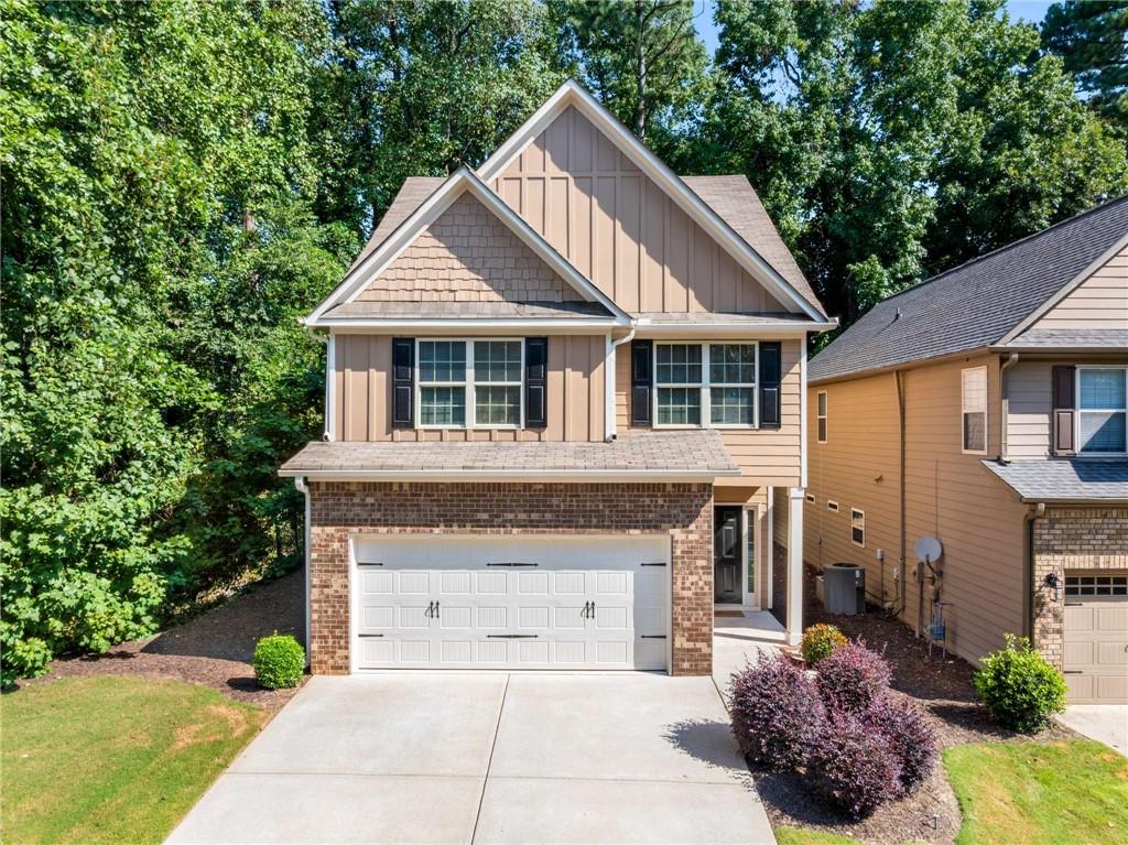 Welcome to Tyson Woods! This move in ready home is located in a secure, gated community within the excellent Cherokee County School District. Step inside to a soaring two story-foyer that invites you into an open family room, dining room concept. Newer luxury vinyl flooring and Fresh, New paint on the main floor create a light, bright charming space to relax, entertain and induce the comfort of home. The kitchen allows you ample space with stained cabinets, an island, a large pantry, and open access to dining and family room to entertain family and friends. Garage access to laundry room flows into the kitchen for easy entry. Enjoy the rear patio for this end unit, which has only one neighbor and offers a peaceful, wooded retreat for a backyard. Upstairs you will find an oversized primary bedroom with a tray ceiling overlooking the wooded backyard. The primary bathroom has plenty of space with a dual vanity, separate shower and soaking tub, along with a large walk in closet. Three other bedrooms offers flexibility for family space, office space and or flex/workout space. Come see this well maintained home in a beautiful community located near Downtown Woodstock, Lake Allatoona, and all the restaurants and shopping near I75/I575.