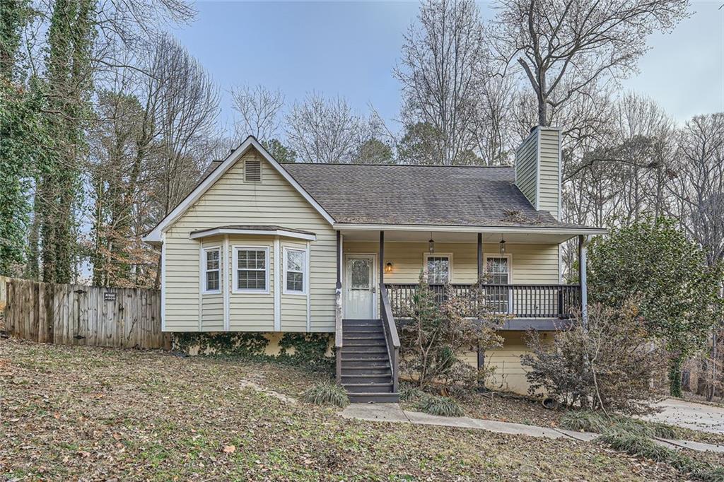Charming 3-bedroom, 2-bathroom home in Acworth, GA, just minutes from Bells Ferry Rd! This inviting home features a spacious living room with vaulted ceilings and a striking stone fireplace as the focal point. A separate dining room provides the perfect space for gatherings, while the main-level primary ensuite offers comfort and style with a tub and shower combo, a new vanity, luxury vinyl plank flooring, a bay window, a large closet, and a stylish barn door. Upstairs, you'll find two additional bedrooms and a beautifully renovated full bathroom. Recent updates include a new HVAC system (approximately 3 months old) and new ceiling fans with remotes installed throughout the home. Step outside to a private, wood-fenced backyard with a spacious deck—perfect for relaxing or entertaining. Enjoy the freedom of NO HOA in this well-maintained home! Discounted rate options and no lender fee future refinancing may be available for qualified buyers of this home.