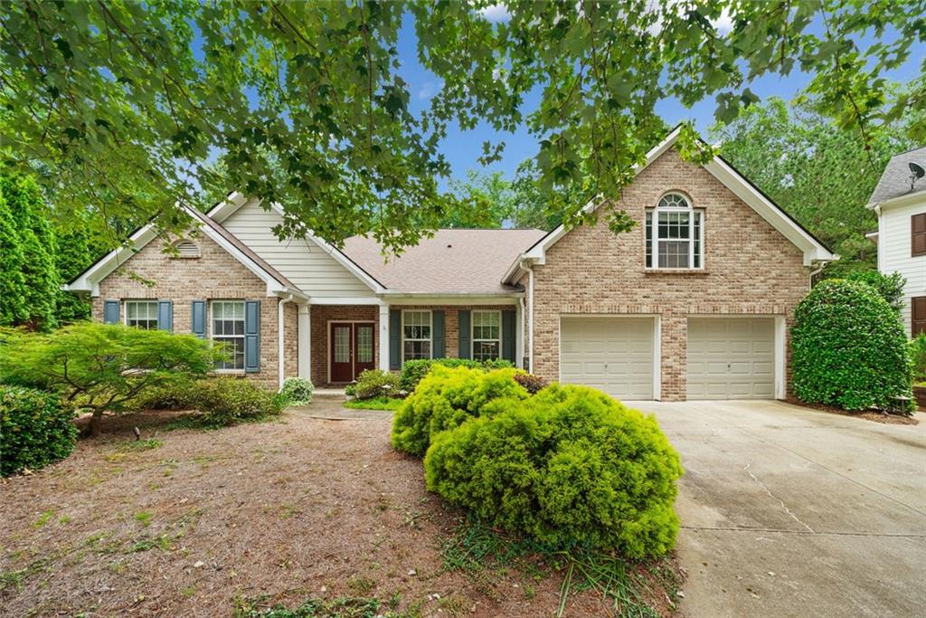 Welcome to this charming split-bedroom ranch plan in a prime location! This beautifully maintained home features soaring vaulted ceilings, a spacious formal dining room, and a family room perfect for your largest furniture pieces. The heart of the home—a pristine kitchen with a center island, separate gas cooktop, walk-in pantry, and new KitchenAid appliances—flows into a cheerful breakfast room with stunning views of the lushly landscaped, fenced backyard. Generously sized owner suite features dual walk-in closets. The owner’s bath offers a walk-in shower, dual vanities, and a therapeutic walk-in tub designed with accessibility features. A dedicated office/library with custom built-ins offers the perfect work-from-home space, and the large bonus room above the garage provides flexibility as a 4th bedroom, hobby room, or guest retreat. Step outside to your own garden sanctuary—complete with an arbor-covered patio, steppingstones, landscape lighting, and charming birdhouses—all backing to a wooded area for exceptional privacy. Fantastic HOA amenities, include a heated pool, tennis and pickleball courts and playground. Located in a quiet cul-de-sac and just minutes from I-85, Hwy 316, Sugarloaf Parkway, shopping, and dining—this immaculate, move-in-ready home is the perfect blend of comfort and convenience!