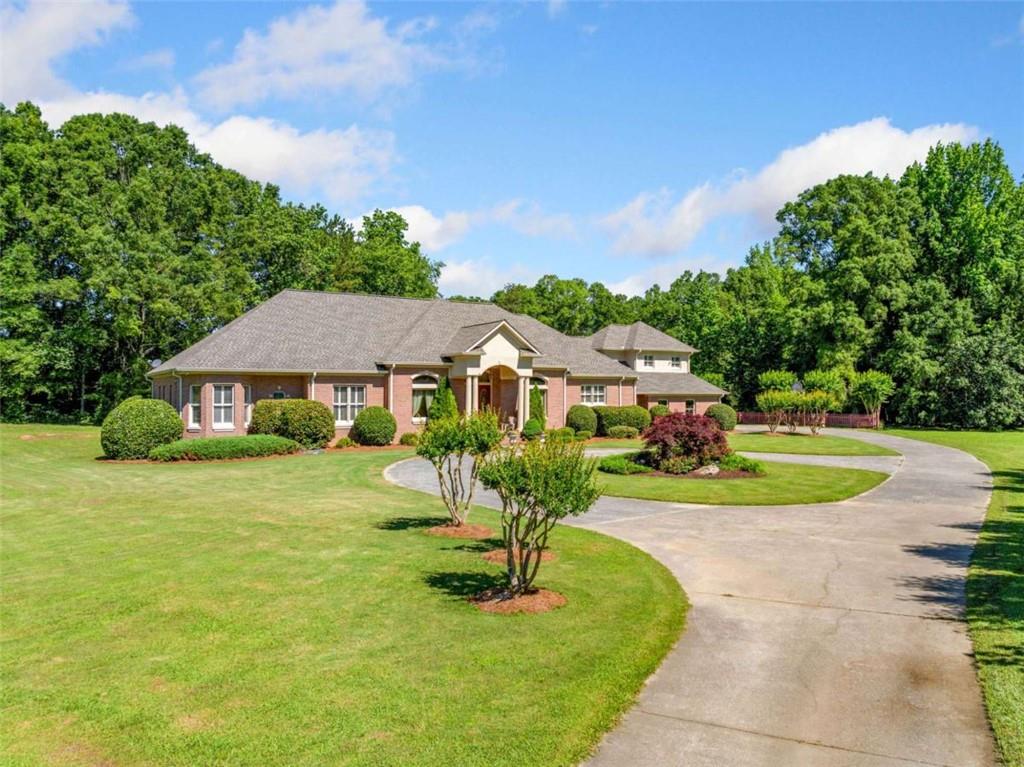 Experience the perfect blend of timeless craftsmanship and modern updates at this custom-built estate on 18.66 picturesque acres in Kingston, Georgia. This four-sided brick home offers enduring quality with 10' ceilings throughout, creating a spacious and elegant interior from the moment you walk in. Thoughtfully maintained and recently updated, the home features a new roof and upgraded systems for peace of mind and energy efficiency. Ideal for entertaining, the expansive covered patio includes a full outdoor kitchen-perfect for hosting gatherings while overlooking serene views of your private pond. The spacious floor plan offers timeless quality and modern comfort. Enjoy year-round entertaining with a covered patio and full outdoor kitchen overlooking peaceful countryside views. A rare opportunity to own a private estate with room to grow, garden, or simply relax and unwind. The land itself is a dream, complete with mature fruit trees, muscadine vines, and room to roam, garden, or expand. Whether you're looking for a peaceful retreat, family homestead, or future investment, this property delivers. It's only a short drive from Euharlee and Cartersville-this one truly has it all! Don't miss this rare opportunity to own a truly exceptional home with land, water, and modern comforts-all within reach of town conveniences.