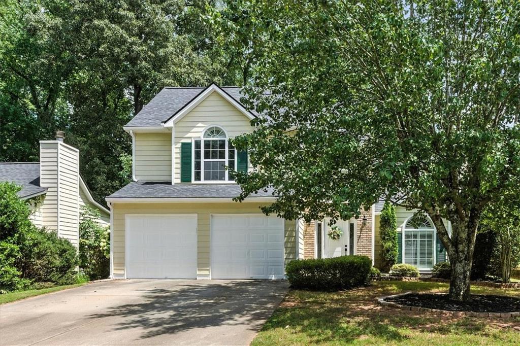 Here’s your chance to get into Lake Park, a quiet and established community known for its charm, amenities, and unbeatable location. From the moment you step into the grand two story foyer, this home feels light, open, and welcoming. Fresh paint and brand new carpet throughout make it move in ready from day one. The living room is filled with natural light pouring through oversized windows, highlighting the spacious layout, and plantation shutters throughout keep the cooling bills at bay. A cozy fireplace adds the perfect touch for relaxed evenings or weekend entertaining. The living and dining areas flow seamlessly into the kitchen, which is both stylish and functional with granite countertops, crisp white cabinetry, a walk in pantry, and a sunny breakfast nook that overlooks the backyard. Tucked away on the main level, the primary suite offers a true retreat with vaulted ceilings and a spacious ensuite featuring a soaking tub, double vanity, and separate shower. The laundry closet is conveniently located nearby. Upstairs, two oversized guest bedrooms are connected by a Jack and Jill bath, offering comfort, flexibility, and brand new carpet underfoot. Outside, the fenced backyard is made for entertaining or everyday unwinding, complete with a refinished deck, expansive patio, and built-in fire pit. The newer roof and freshly painted two car garage adds even more value, while neighborhood amenities like two pools, tennis courts, basketball courts, playgrounds, and sand volleyball court seal the deal. With quick access to shopping, dining, and major commuter routes, this home delivers the lifestyle you’ve been looking for in one of the area’s most welcoming neighborhoods.