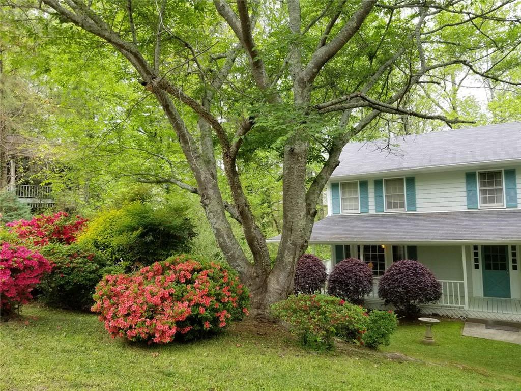 Seller needs to move ASAP and offering $10K in closing costs with acceptable offer!
Excellent opportunity to buy into one of NE Cobb's prettiest neighborhoods in Lassiter/Mabry/Garrison Mill school district. This lush, green area of gentle hills is reminiscent of neighborhoods in the north GA mountains. Over $80K in upgrades since 2020 including all new flooring (April 2025), new upgraded architectural shingle roof & new chimney cap (11/2024) with transferrable warranty. Fresh paint throughout (11/2024). Newer deck, siding and exterior paint, and new garage doors (2020). New $30k basement Everdryâ„¢ system and EZ Breatheâ„¢ ventilation system with Lifetime Transferable Warranty (2025).
This traditional home is located on a quiet double cul de sac street, easy walking distance to the pool/tennis/playground/school bus stop. Southern charm ON NEARLY 1/2 ACRE in a very serene park-like setting! Enjoy outdoor living on the covered wraparound porch (porch swing stays) and open rear deck which overlooks the flat, woodsy, very private backyard with a small creek running through the back of the property. Deer are often spotted traveling along the creekbed.
The mature landscaping includes magnolia, cherry, maple, dogwood and tulip magnolia as well as azaleas and other ornamentals.
Inside this home you step in to a welcoming entry space with hardwood floor. Crown molding and bay windows featured on main level. All rooms are large, offering flexible furniture placement. Main living space features a large living room, den with fireplace, half bath and laundry, large eat-in kitchen and formal dining room/flex space, suitable for an office/yoga retreat with access to the side porch & porch swing with views of the woods in back. Upstairs you will find a 4-bedroom split plan with a large primary en-suite, 3 secondary bedrooms and 2nd full bathroom. En suite features a large bedroom with gas log fireplace, 2 closets, jetted tub with separate shower. Very large basement/rear entry 2 car garage and large parking area in the back of the home. Lots of storage including overhead hanging storage for kayaks, ladders, etc. The private backyard is level with several trees. It has been used for activities like a trampoline, fire pit, and even a camping area. Relaxed HOA. Imagine morning coffee and evening wind-downs outside with gorgeous views. There is a beautiful view from every window in the house.
A MUST-see!
Quick closing - move in before August!
