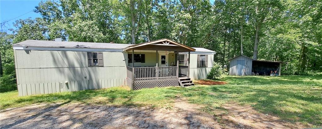 An investor's dream with income already flowing! This updated mobile home sits on a permanent foundation with retired titles, making it financeable and a fantastic long-term investment. Corner, private 1.31-acre lot, the property offers both seclusion and convenience, located just off Hwy 9 for easy access to shopping, dining, and commuting routes. This well-maintained home features updates that appeal to today's renters, and there's already a wonderful tenant in place, making this a turnkey investment with no vacancy downtime. A major bonus is the on-site storage building, ideal for tools, lawn gear, or even additional rental storage potential. With no HOA restrictions, you'll have the freedom to manage the property. The location, income potential, and existing setup make this property an ideal addition to any investor's portfolio.