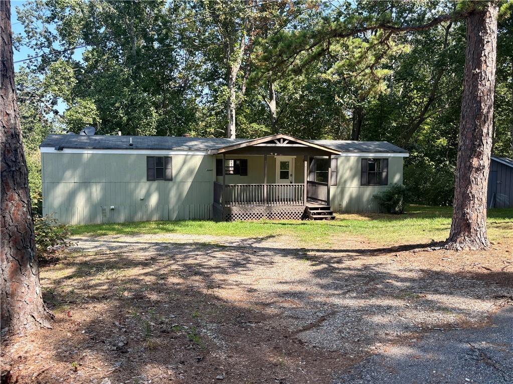 2/1 mobile home sits on a permanent foundation with retired titles, making it financeable and a fantastic long-term investment. Corner, private 1.31-acre lot, the property offers both seclusion and convenience, located just off Hwy 9 for easy access to shopping, dining, and commuting route. This well-maintained home features updates that appeal to today's buyer and/or renters. A major bonus is the on-site storage building, ideal for tools, lawn gear, etc.
With no HOA restrictions, you'll have the freedom you want with the property, so much potential with this one!