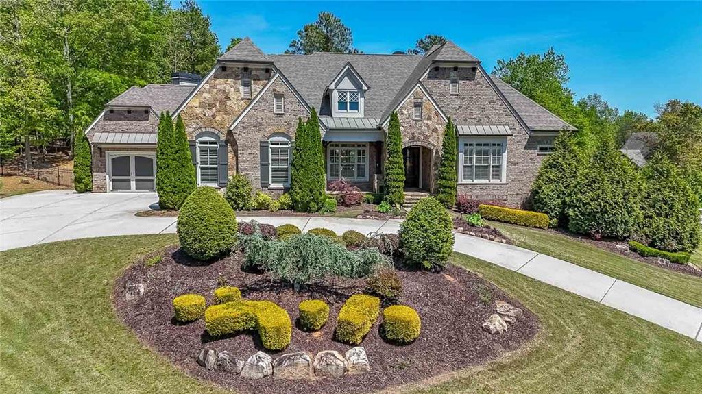 Stunning TRUE ranch home that was CUSTOM-BUILT with hard to find direct walk-out to the backyard.  And what a backyard it is!  Sparkling spa and pool with fabulous sun-shelf and dancing jets,  Gazebo and outdoor kitchen. So much room for easy family fun or large scale entertaining.  And the house is just as fabulous as the backyard.  Located in the premium section, Sarazen's Corner, of the community, immerse yourself in the elegance and sophistication of this one-of-a-kind masterpiece.  Designed with both comfort and entertainment in mind, the open floor plan is light and bright, and opens to the backyard to seamlessly blend inside and outside living. Feels like brand new and has tons of natural light.  The state-of-the-art kitchen has an oversized island, exquisite cabinetry, high-end appliances and extra-large walk-in pantry. Around the corner is a handy butler's pantry. The great room has a fireplace, bookcase, and coffered ceiling.  The keeping room has a second fireplace, bookcases, and a vaulted and beamed ceiling.  The master suite is a haven away from the hustle and bustle of daily life and has two large closets.  Two additional large bedroom suites complete the first floor.  The terrace level has brand new floors and is furnished with an entertaining bar, billiards room, media room, game room, three large guest suites, plus lots of storage room. The 3-car garage is off of mudroom on main level. Property comes with a golf membership with initiation fee of $15,000 already paid.