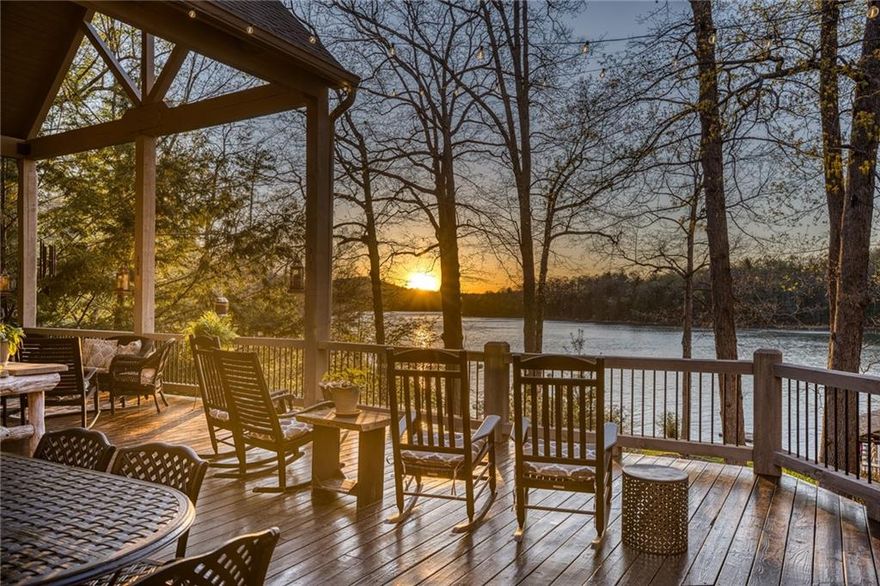 Welcome to Hemlock Pointe! Located in Star Creek, this lovely house is perfect for large families that love lake living and sunsets. Situated on .9 acre lot and surrounded by native hemlock and white oaks, Hemlock Pointe sits on the edge of a creek that creates a point and offers wide views with over 150 feet of shoreline on Beautiful Lake Blue Ridge. Enjoy living and entertaining with lakefront views from all rooms! Just under 7,000 heated square feet spread over 3 levels with 7 Bedrooms and 7 1/2 baths. The house features a two story living room with 12’ windows, tongue & groove ceilings with beams and a floor to ceiling fireplace. You will love the newly remodeled kitchen with Bosch, Thermadore and Subzero Appliances, wet bar, wine cooler, ice maker and large dining area. The laundry/mudroom is just off the 2-car garage. The main level offers 2 Main suites with adjoining screened porches. All rooms on the main level open onto porches and over 700’ of lakeside deck. Upstairs offers 2 additional bedrooms with private baths.  The terrace level is great for family fun with fireplace, wet bar, pool table and walk out patio. This level has 2 additional bedrooms with private baths,  There is also nice storage for all your lake toys. Not only is there a huge deck that is partially covered, but you can enjoy the 16’ x 16’ lakeside pavilion with electricity, satellite, WiFi and a wood-burning stove and large fire pit area overlooking lake.  The 2 slip party dock has sunning area and place for jet ski storage and a swim platform.  The shoreline is protected with a 140’ retaining wall. You will enjoy the extensive landscape and “moon” lighting, perennial gardens, putting green, creek, enclosed outdoor shower, natural stone walls and walkways that make this the best house on the lake. This home is timeless. Only 2 families have been fortunate to live here. Built and furnished by the founder of America's Home Showplace and Carpets of Dalton, it was designed to be a refuge in the beauty of the surrounding national forest,  a place for family gatherings and for making memories. The combination of it’s location on the lake, a large, level lot with year-round access to deep water and being surrounded by US Forestry Service land creates a perfect setting that cannot be found anywhere else on the lake Blue Ridge.  Blue Ridge offers a great downtown area for shopping and dining.  The marina is a short boat ride away for lunch.  Hiking and bike trails everywhere.  What a great place to make memories in this beautiful house on Lake Blue Ridge.  This home comes furnished with some exceptions.