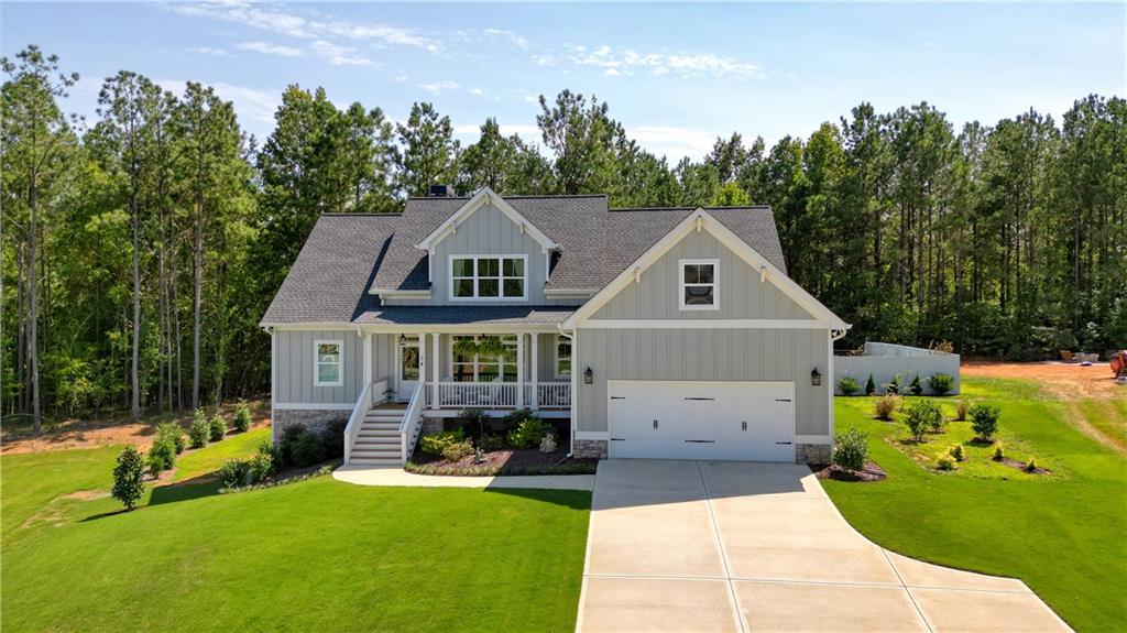This stunning almost new ranch home with builder upgrades throughout combines timeless design with modern comforts and is move-in ready. From the welcoming front porch to the covered back deck, every detail invites you to relax and enjoy. Featuring your own private saltwater inground pool with cleaning system and cover, this meticulously maintained 3-bedroom, 2.5-bath home with a versatile bonus room/Loft that can easily serve as a 4th bedroom with its own bathroom is a true standout. For added flexibility, the full unfinished daylight basement awaits your personal touch, whether you’re looking to expand your living space, design the perfect workshop, or create a home gym.
Inside, the open-concept layout showcases gleaming hardwoods in the foyer, dining room with coffered ceilings, kitchen, living room, and pantry, crown moulding, and windows that fill the space with natural light. The chef’s kitchen features stainless steel appliances, granite countertops, soft close cabinets with the open concept living and dining areas that provide the perfect backdrop for gatherings with family and friends. The recently added sunroom off the kitchen offers even more entertainment space or just a space to relax.
The main-level primary suite is a private retreat with 9-foot coffered ceilings, a spa-like bath featuring a freestanding tub, a tiled shower with bench, and elegant finishes throughout. Two additional bedrooms are located on the main level with a tiled Jack and Jill bath, and a fourth bedroom and full bath option upstairs offering flexibility for a home office, guest suite, or creative space.
Outdoor living is equally inviting, with a covered back patio perfect for morning coffee or evening entertaining with its landscaped backyard and inground saltwater pool.
Conveniently located just 15 minutes from shopping, dining, grocery stores, and Downtown Cartersville, this like-new home offers both style and functionality in a sought-after community.