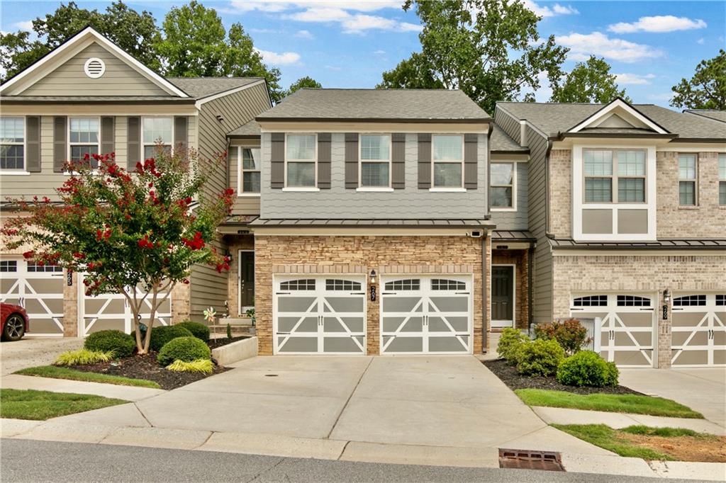 Updated Luxury Townhome close to Downtown Woodstock! 4 Bedrooms and 3.5 Baths. The Covered Front Porch welcomes you. Open Concept Floor Plan with Soft Neutral Colors, Updated Fixtures, Plantation Shutters and Hardwood Floors throughout Main Level. Modern Kitchen features Granite Counters, White Cabinets, Tile Backsplash & Large Center Island. Separate Dining Area. Spacious Family Room with Great Natural Light and Gas Logs Fireplace. Hardwood Stairs lead you to a Split Bedroom Plan with Spacious Primary Suite including Large Master Closet. Master Bath boasts Double Vanity with Granite Counters and Large Walk-in Shower. Separating Bedrooms is a Cozy Loft Area for TV, Gaming, Reading, etc. Secondary Bedrooms have Walk-in Closets and Adjacent Full Bath. Large, Open Finished Basement for 4th Bedroom and Full Updated Bath. This area includes Office Nook for Quiet and Privacy. There is also Plenty of Storage Space with Multiple Oversized Closets. Basement walks out to a Shaded Patio and Green Space Perfect for Kids and Pets. There is also an Extended Double Size Private Balcony for Quiet Evenings & Saturday Morning coffee. Property within easy walking distance of Ample Overflow Parking. Stoney Creek is a Manicured, Walkable Community with a Beautiful Pool. HOA covers Grounds Maintenance, Dwelling Exterior, Roof, Swim, Etc. Fee Simple Townhome. Great Woodstock Location near all the shops and restaurants in Downtown. Convenient to Sixes Road and I-575. Sought after Ridgeview High School.