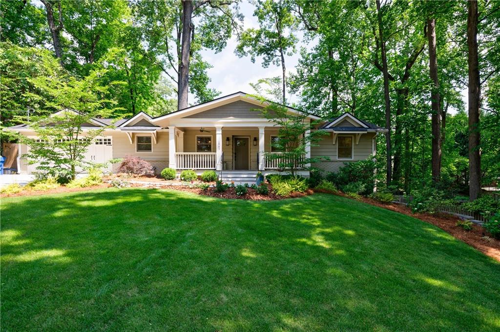 Stunning home with a rocking chair front porch on a friendly cul-de-sac in sought-after Channing Valley. It is perfectly situated in the Morris Brandon School, within walking distance of Channing Park, Bobby Jones Golf Course, Bitsy Grant Tennis, the Beltline and fabulous restaurants and shopping! The main level boasts an open floor plan, with custom moldings and design throughout, a rare expansive walkout lot, beautifully landscaped, finished downstairs and an oversized two car garage, with room for a workshop.
The kitchen is an absolute dream featuring a vaulted ceiling, custom cabinetry, black stainless appliances, honed quartz countertops, and a generous island that opens to the family room. Butler's Pantry/coffee bar off the kitchen is stubbed for laundry. The dining room has French doors to the back newly expanded deck and wood privacy fence. The primary suite on the main level has a luxurious spa-like bath experience that will leave you feeling refreshed and rejuvenated, including a double vanity, honed marble counters, marble walk-in oversized shower, and soaking tub - plus a walk-in Custom closet. Original hardwoods throughout the main level. The second bath on the main level has honed marble counters, subway tiles and frameless door for the tub/shower. The terrace level has two bedrooms with a marble bath. A second living space on the terrace level is stubbed for a kitchen, wet bar, or both. Large laundry room with custom storage and generous built in hanging bar.This 2020 rebuild to the studs includes 100% new electrical, plumbing, dual-system HVAC, lifetime waterproofing, ceiling fans in every room, built-in speakers throughout, smart home wired, new gutters, roof, and a new driveway. The neighborhood has a charming park with a playground and soccer/baseball field, and hosts events year-round, including “Summer Fridays in the park" gatherings, Easter Egg Hunts, Halloween festivities, Christmas parties, a book club and so much more! A hidden treasure close to Piedmont Hospital, everything Atlanta and the Upper West Side development.