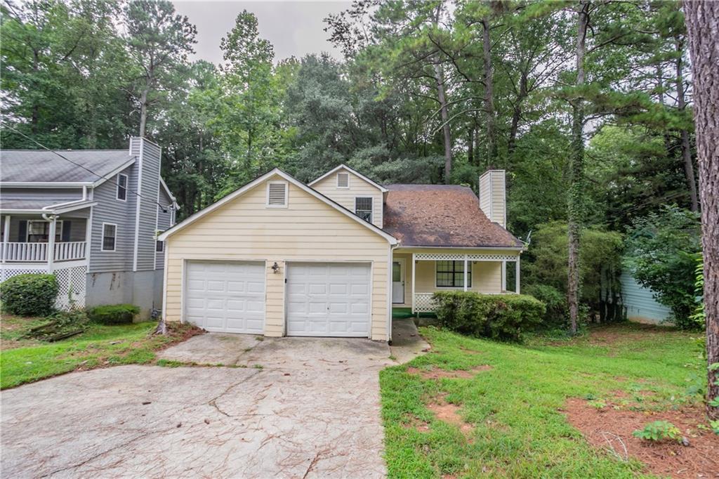 Charming traditional two-story home located in the quiet Chedworth community of Stone Mountain. This 3-bedroom, 2-bath residence welcomes you with a covered front porch and a bright family room featuring a decorative fireplace. The dining area opens with sliding doors to a spacious deck overlooking a private, wooded backyard—perfect for relaxing or entertaining. The home includes an eat-in kitchen with views to the living area, generous bedroom space, and walk-in closets for storage. Nestled in a peaceful neighborhood with mature trees and streetlights, this property offers both privacy and easy access to major conveniences.