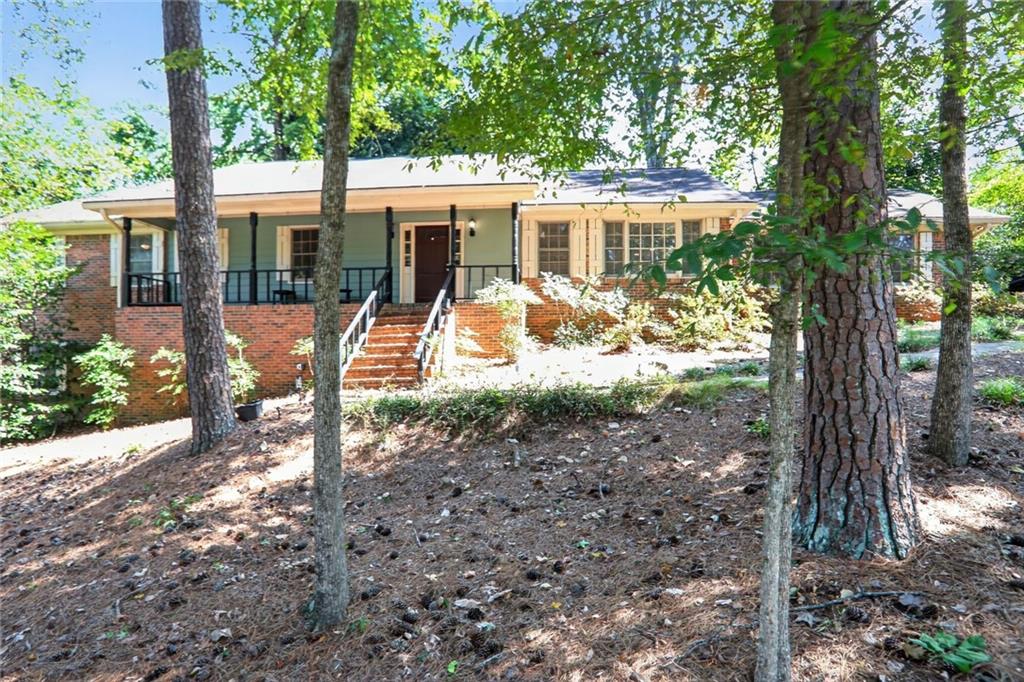 Spacious ranch on a finished basement with in-ground pool and pool house in a fantastic location with no HOA. The updated kitchen features wood cabinetry, new quartz counters, tile backsplash, breakfast area, and all appliances including refrigerator, gas cooktop, wall oven, microwave, and dishwasher. A separate dining room and vaulted family room with tile floors, skylights, and a gas log fireplace provide great living space. The main level offers two bedrooms with tile flooring and ceiling fans that share a Jack & Jill bath, along with a primary suite that includes tile floors, ceiling fan, dual vanity bath with built-in drawers, separate closet, and tub/shower combo that also opens to the hall. The basement includes an additional bedroom, full bath, large bonus room with a second kitchen, and exterior access to the backyard and pool. Additional features include a laundry room with wood cabinets, a freshly painted interior, and a two-car side-entry garage. Square footage does not reflect the finished basement areas. Excellent location near Henderson Park with easy access to I-85 and I-285, just minutes from Atlanta, dining, shopping, CDC, and Emory, and in a great school district.