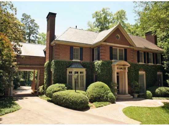 Handsome all brick home (circa 1924), set back from street on 2.42 acres of rolling lawn, gardens and mature hardwoods. Slate roof, gracious foyer with arched doorways, 10'+ ceilings on main level, original hardwood floors, 6 wood-burning, masonry fireplaces (3 in bedrooms), crown moulding and raised panel walls throughout. Renovated kitchen overlooks family room; wet bar, two powder rooms, custom bookshelves; French doors in dining, living and family rooms leading to lovely, private gardens, covered porch ,pool and lighted tennis court. Add'l bdrm/bath 3rd floor.