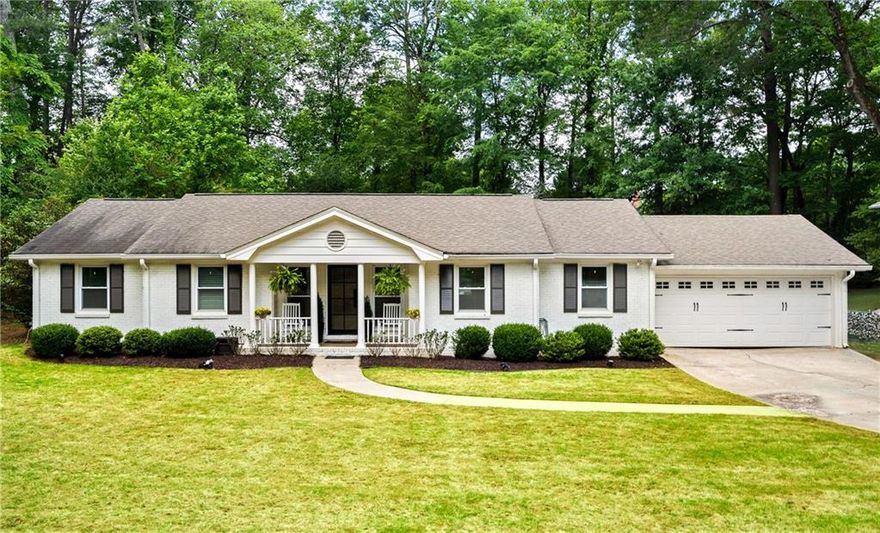 A rare Brookhaven opportunity offering an unbeatable blend of location, charm, and a beautifully curated outdoor lifestyle. Set on an expansive, flat lot just under half an acre and surrounded by luxury homes, this 3-bed, 2-bath residence delivers effortless living in one of the area’s most coveted pockets.
A custom iron-and-glass door opens into an inviting, open-concept living space ideal for everyday living and entertaining. The kitchen showcases Cambria quartz countertops, stainless steel appliances, custom dark-blue cabinetry, and a generous 9-foot island with seating. The family room features a warm fireplace and sun-filled windows, while original hardwood floors run throughout, bringing timeless character to the home. The primary suite includes a private ensuite with a vanity and frameless tile shower. Additional highlights include a brand-new water heater, washer, and dryer. The expansive backyard is a true retreat with a large deck perfect for hosting gatherings, grilling, or simply enjoying the privacy of the oversized lot. The home’s exterior is fully landscaped with zoysia grass and a full irrigation system. The location is unmatched — enjoy walkability to Murphey Candler Park, Blackburn Park, and Keswick Park, with quick access to top dining and shopping throughout Brookhaven, Chamblee, and the Perimeter area.