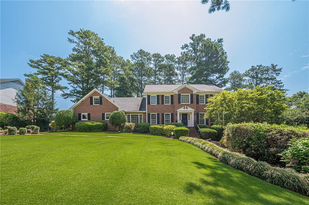 Welcome to 5233 Wynterhall Drive, a beautifully maintained home in one of Dunwoody’s most desirable neighborhoods. This spacious property offers a perfect blend of timeless charm and everyday functionality, featuring generous living areas, an updated kitchen, and multiple spaces for gathering and entertaining.
One of the standout features is the expansive sunroom—filled with natural light and overlooking the private backyard—perfect for relaxing or hosting guests year-round. Upstairs, you’ll find well-sized bedrooms, including a large primary suite with ample closet space and a private en-suite bath. The finished basement offers even more flexibility with a dedicated wine cellar, plus space ideal for a home office, gym, playroom, or guest suite. Outside, enjoy a peaceful, landscaped backyard with plenty of room to garden, play, or entertain. Located on a quiet, tree-lined street with easy access to top-rated schools, shopping, dining, parks, and major highways. Optional membership to the Wynterhall Swim & Tennis Club—just a short walk away—offers access to a vibrant social scene, pool, tennis courts, and seasonal events. Don’t miss the opportunity to make this exceptional property your next home!