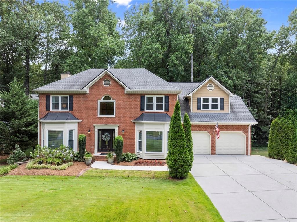Create lasting memories in this traditional beauty, nestled in the welcoming East Cobb swim and tennis community of Windsor Oaks. Situated on a flat lot, this home combines elegance with modern convenience. You’ll first notice the impressive curb appeal featuring mature landscaping, a stately brick exterior, and a two-car garage. Inside, every room has been thoughtfully updated and meticulously maintained, providing comfort, quality, and lasting peace of mind. Host dinner parties in the separate dining room and enjoy cooking in the upgraded kitchen, featuring custom cabinetry, granite countertops, under cabinet lights, tile backsplash, electric range, and plenty of storage. Relax fireside in the family room by the brick fireplace, surrounded by built-ins for extra storage. Enjoy year-round outdoor living on the spacious screened-in porch, complete with a ceiling fan, recessed lighting, and room to relax or entertain. Just outside, a
dedicated grilling area makes cookouts a breeze. Escape to the spacious primary suite with a trey ceiling and generous walk-in closet. Indulge in the updated en-suite bathroom, complete with separate granite vanities, updated lighting and fixtures, tile floors, a separate tub, and a tiled walk-in shower with built-in shelving. Upstairs, you’ll find plenty of room for family or guests with three additional bedrooms that share an updated bathroom with on-trend tile flooring, a tub/shower combo, separate vanities with stylish fixtures, lighting. The finished terrace level offers flexible space with luxury vinyl plank flooring, spacious media room, two bedrooms, work-in room, and a newly updated full bath, ideal for a teen suite, in-law space, or guests. Step into your own backyard sanctuary designed for connection. Gather around the firepit, watch the kids explore the playset, or host friends and family on the spacious, tree-lined lawn. The private, flat backyard is a rare find in Windsor Oaks. The award-winning schools, neighborhood events and amenities including 2 event pavilions, 4 brand new tennis courts, brand new multi-purpose court for pickleball and basketball, pool, and playground complete the attributes that make this a must have home. Don’t miss your chance to own this entertainer’s dream home in one of East Cobb’s top-rated school districts!