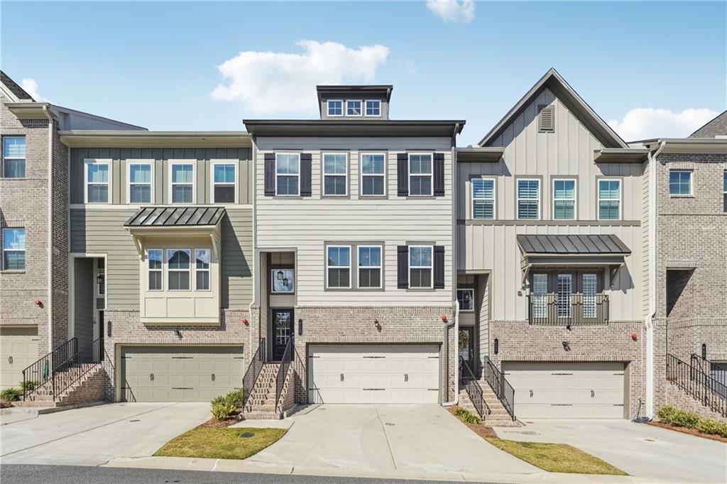 Discover this beautifully maintained, north-facing townhome in the heart of Smyrna's Cumberland Station! – Furnished and Move-In Ready!
This turnkey property comes complete with almost all furnishings included in the sale price. The home is being offered beautifully furnished and decorated, with the seller leaving behind all furniture and decor except for the living room TV, the red rocking chair in guest room, the dresser in the guest room and the tall dining room shelf. Walk in and start living - everything from the comfortable furniture to the kitchen essentials stays with the home. This rare opportunity allows you to skip the hassle of furniture shopping and moving expenses! A rare find with NO RENT RESTRICTIONS and walking distance to The Battery. This exceptional property offers 4 bedrooms, each boasting a private en-suite bathroom, perfectly positioned in a peaceful, welcoming community. Natural light floods the open floor plan, where a gracious living room showcases custom built-in bookcases. The modern kitchen impresses with quartz countertops, stainless steel appliances, and an expansive island ideal for entertaining. An extended wall of cabinetry provides abundant storage, while the kitchen overlooks a second living space, dining area, and versatile expansion area – perfect for a sitting room or home office. Upstairs, find two primary suites, each offering a spa-inspired en-suite bathroom and generous walk-in closet. The lower level presents a third living/flex space alongside another private bedroom suite. A tranquil private backyard creates the perfect setting for relaxation or social gatherings. Located moments from Smyrna Market Village and Truist Park, with easy access to major highways, this home combines investment potential with lifestyle convenience. Experience the perfect blend of comfort, style, and location in this turnkey property. Schedule your viewing today!