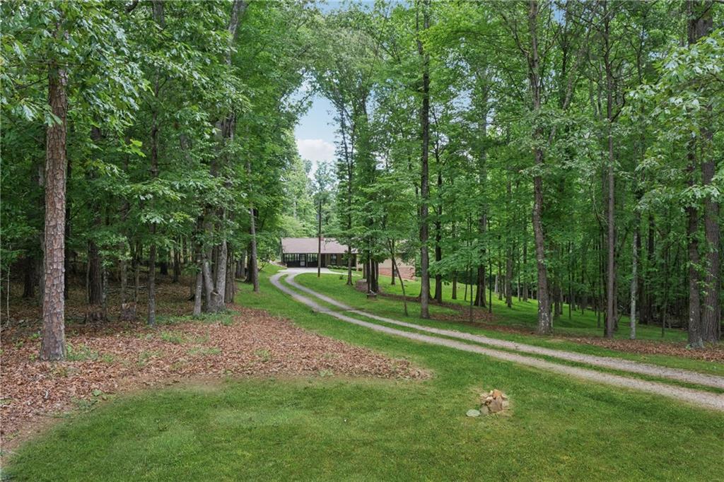 Discover 7.26 picturesque acres just minutes from the expansive 137-acre Milton City Park & Preserve—offering scenic trails, a community pool, tennis center, and more. This rare property features a charming 1,400 sq ft ranch-style home built in 1980, with 3 bedrooms, 2 full baths, an open-concept kitchen and family room, and a spacious sunroom equipped with its own split HVAC system for year-round comfort.
Endless potential awaits—renovate or expand the existing home to create your own private estate, or take advantage of the generous acreage to design pastures, a riding arena, and a barn for equestrian living. Alternatively, the land offers potential for subdivision into 2+ acre lots for custom dream homes.
Currently serviced by a well, the property also has access to county water at the road. Enjoy convenient proximity to parks, acclaimed restaurants, boutique shopping, and the vibrant downtown Alpharetta. Families will appreciate access to top-rated schools including Birmingham Falls Elementary, Hopewell Middle, Cambridge High School, and nearby King’s Ridge Christian School.
Don't miss this unique chance to own a slice of Milton’s most desirable landscape!