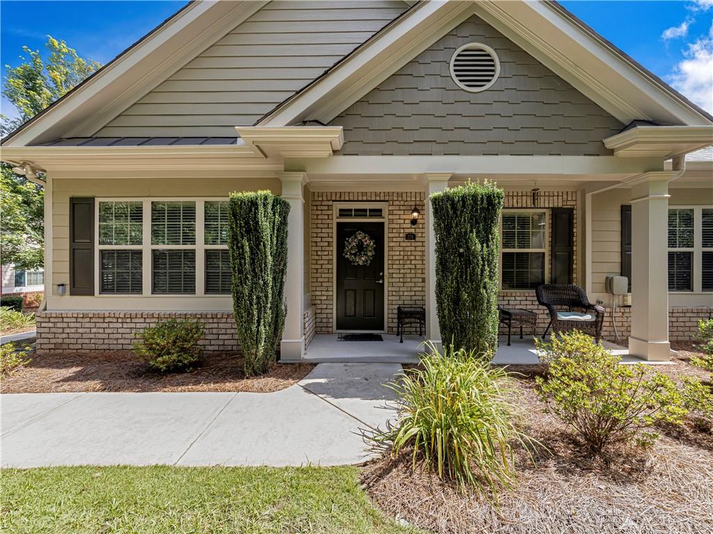 Meticulously Maintained Home Awaits You In The Orchards of East Cherokee! The home is situated in a tranquil and private corner of this desirable active adult community offering a truly exceptional lifestyle. Admire the impressive original builder upgrades, including elegant and rich trim, trey ceilings, and custom built-in cabinetry in the stylish and inviting family room. The kitchen is a chef's delight, featuring an extra wall of cabinets and recently installed high-end quartzite countertops with a stylish subway tile backsplash (2025). Real hardwood floors extend throughout the main level, including a sun-filled four-seasons room. Recent updates include fresh paint throughout and upgraded lighting fixtures (2022), creating a bright and inviting atmosphere. The main level provides comfortable living with two bedrooms and two full bathrooms, while the upstairs bonus room (very spacious for a king size bed and a large sitting area) with a full bath is ideal for hosting overnight guests. Key maintenance updates ensure peace of mind, including a new hot water tank (2025) with an instant hot water system and regular HVAC servicing. Enjoy a maintenance-free exterior, with the HOA maintaining lawn care, painting, and roofing. Walk to the community clubhouse, offering a fitness area and kitchen, next to the pool. It's prime location near downtown Woodstock, Canton, and Holly Springs puts you close to dining, shopping, and the convenience of Northside Cherokee hospital. This is more than a home; it's a vibrant lifestyle opportunity in a welcoming active adult community.