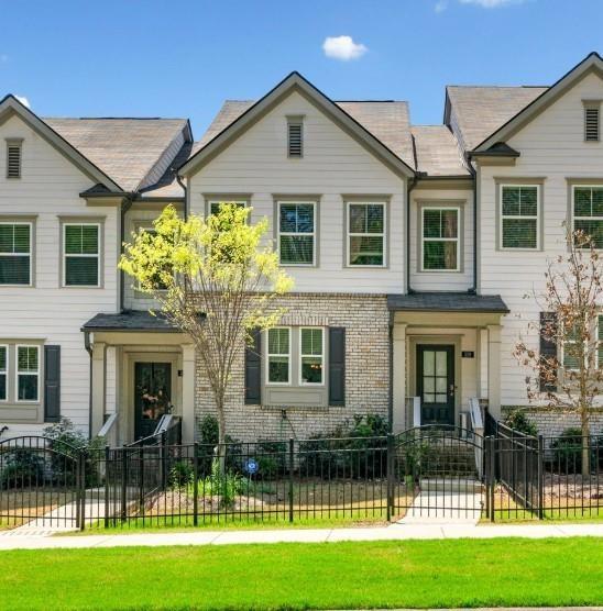 GREAT OPPORTUNITY!! Welcome to this beautiful modern townhome nestled in the heart of the highly desirable Towne Lake area of Woodstock! This stylish residence showcases a bright and open-concept floor plan designed for both entertaining and comfortable everyday living. The main level features a spacious family room that flows seamlessly into a modern eat-in kitchen complete with stainless steel appliances, stone countertops, a large kitchen island, walk-in pantry, and views into the great room. Enjoy elevated finishes such as high ceilings, smart home features, a built-in Pest Control System from PestBan, and high-speed internet capability throughout the home. Upstairs, retreat to the luxurious primary suite, boasting a walk-in closet, a double vanity, and a sleek shower-only layout in the primary bath. Two secondary bedrooms offer flexibility for guests, children, or a home office, all served by a full bath and a conveniently located laundry room on the upper level. The terrace level adds even more versatility with a finished space—perfect for a home office, media room, or guest suite—along with a full bathroom. Relax outdoors on the rear deck, covered front porch, or enjoy the fenced front yard, ideal for pets or play. Benefit from sidewalk-lined streets, street lights, and a friendly, walkable community near top-rated schools and easy highway access. Just steps away from the scenic Greenprints Trail System, this home offers the perfect blend of nature, convenience, and comfort. Enjoy direct access to miles of walking and biking trails, with Downtown Woodstock, Reformation Brewery, and The Outlet Shoppes at Atlanta just minutes away. Dining, shopping, live music, and local events are always within reach. NO RENTAL RESTRICTIONS!