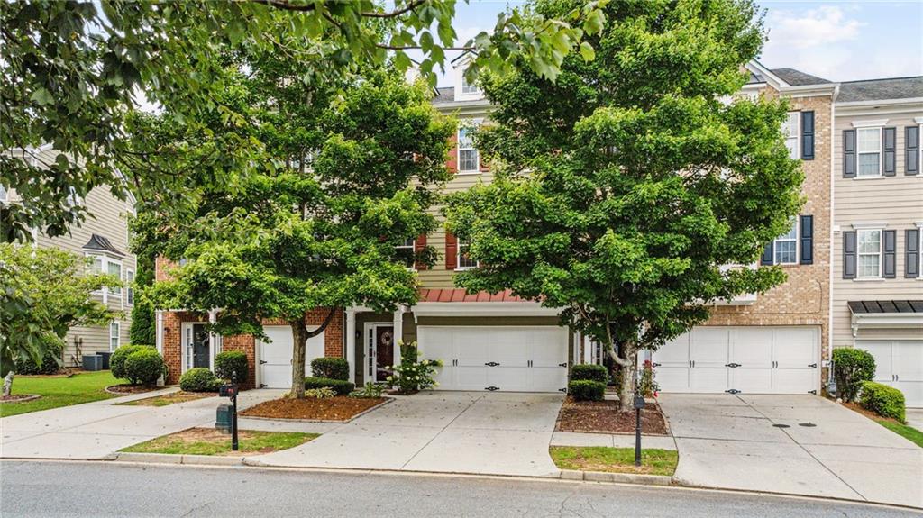 Welcome home to peace and serenity in the heart of Suwanee!
Discover one of the largest and most desirable floor plans in the sought-after Suwanee Station community. This beautifully maintained, move-in-ready townhome offers the rare luxury of a private backyard oasis—yes, actual yard space in a townhome! Step inside to find a spacious entry-level guest suite complete with a full bath and direct access to the serene backyard, perfect for relaxing on the porch swing and enjoying the peaceful sounds of nature. As you make your way upstairs, you will be welcomed by a bright and airy open-concept living space, where natural light fills the room from every angle. The expansive kitchen flows effortlessly into a casual dining area and offers direct access to the back deck—perfect for taking in tranquil views and peaceful surroundings. The top level features two expansive bedrooms, each designed as a private owner’s suite, both with walk-in closets and ample space for comfort and relaxation. Just a few features of this home include: all new windows installed in 2019, a new roof installed in 2024, fresh interior and exterior paint, and the washer and dryer is included. The HVAC has a Captura germicidal UV system which provides several benefits, including improved air quality, enhanced system efficiency, and potential cost savings. Enjoy the convenience of a front-level entry garage with additional storage space, making parking a breeze for you and your guests. This home has convenient access to all of the resort style amenities that Suwanee Station offers including an Olympic-sized pool, multiple tennis and pickleball courts, clubhouse, walking trails, and more. They say location is everything—and Suwanee Station delivers. Just minutes away, you will find Suwanee Town Center, where timeless small-town charm meets the lively energy of local dining, boutique shopping, community events, and concerts—all with easy access to the scenic greenway and walking trails. This is the one you have been waiting for!