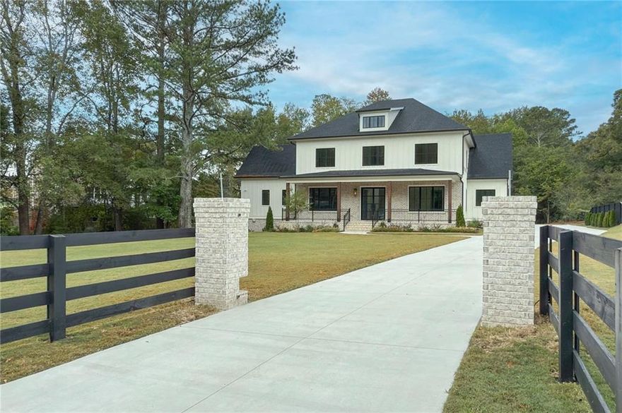 This gated, brand-new construction residence offers luxury living in a prime Downtown Alpharetta location with room to expand and customize the terrace level. This beautiful home offers a walkout backyard from the main level and is situated on a large and private, fenced and gated +/- 1.6-acre lot ideal for a potential pool. The sliding doors from the living room open to the spacious covered porch, offering the perfect place to enjoy outdoor living year-round. The interior is spectacular with the gourmet kitchen and owner's suite on the main level! Located in an ideal location that is nearby to both Downtown Alpharetta and Crabapple Market, this stunning new build is a seamless blend of traditional southern elegance and modern convenience. Step inside the grand 2-story foyer to discover a bright and airy interior flooded with natural light from the oversized custom windows, and bespoke attention to detail that shines through custom trim and wood accents, arched doorways, vaulted ceilings, architectural beams, and designer fixtures and finishes throughout. Beyond the inviting foyer, the spacious great room beckons for hosting and gathering. Sliding doors open to the expansive covered patio, complete with a fireplace that overlooks the abundant green space, ideal for both entertaining and everyday enjoyment. The flat, private backyard is a perfect canvas for a potential pool and custom outdoor oasis. The primary suite on the main level is also a true interior retreat with its own views of the backyard and direct access to the outdoor space. The primary ensuite boasts gorgeous dual vanities, a large frameless shower and luxurious soaking tub. Meanwhile the open kitchen is a chef's delight, featuring an oversized eat-in island, stunning range hood accentuated by a custom scalloped backsplash, gourmet appliances, and custom cabinetry, including a pantry wall of deep-set cabinets that discreetly maximizes storage space. Form further meets function with a jewel box of a scullery that serves as a secondary kitchen to meet your entertaining needs and organize appliances and cookware. The spacious dining room is connected to the kitchen via a butler's pantry for added convenience while hosting guests. Across the entryway from the dining room is an elegant study complete with custom floor-to-ceiling wainscoting. The main level features 10-ft ceilings and is complete with an expansive mudroom with additional custom cabinetry and bench seating, and an additional flex space that can be used as a secondary office or drop zone/storage space. Laundry rooms on both the main level and upstairs ensure the ultimate convenience for everyday living. Spacious bedrooms await upstairs, along with a large open loft area that can be customized for added relaxation and recreation opportunities. Each bathroom showcases unique pops of color and curated tile selections that add a custom touch and element of fun. The terrace level offers further endless possibilities for customization that can be finished to your specification and priced accordingly. The oversized, side-entry 3-car garage further maximizes everyday function and storage. Enjoy the close proximity to Downtown Alpharetta and Crabapple Market with sidewalks connecting both areas, and take advantage of living nearby to coveted restaurants, retail and entertainment opportunities. For added privacy, the home will be entirely fenced with a custom gate to the driveway. The entire lot is enveloped by greenery with an amazing covered front porch and gas lanterns that frame the double set of glass front doors that add a touch of modern to the exterior. Contact us today to schedule a private tour of the property and work with an experienced local builder, European Manor.