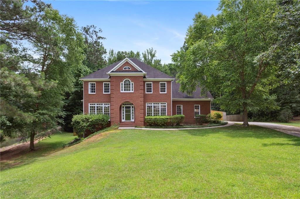 Incredible opportunity! You don't want to miss this beautiful home situated on a rare 1+ acre lot on a cul-de-sac, offering direct access to the community catch and release pond. Relax in the gazebo or your freshly redone entertaining deck and take in the natural and picturesque views. Inside you will find an open concept and updated kitchen with new quartz counters, new sink and faucets and new lighting. The family room features a gas starter, wood burning fireplace. The large Owner's suite is complete with an updated spa-inspired bathroom with all new plumbing, new quartz countertops, new faucets, new light fixtures, new shower tile surround and a new gorgeous free-standing tub. The interior of the home has been freshly painted and new light fixtures have been installed throughout. The secondary bedrooms are a good size, too! The full finished daylight basement offers lots of flexibility. The large rooms are perfect for games, hobbies or entertaining. The home also features a freshly painted two-bay main garage with separate third drive-under garage bay, perfect for an extra car or boat. The exterior of the home has been freshly painted as well. You can't beat the locations, just minutes away from Marietta Square with easy access to amazing restaurants, shopping and 575.