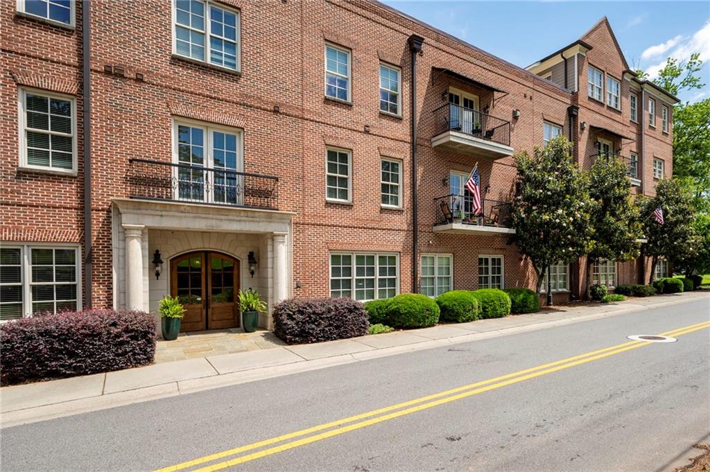 Do not miss out on this corner unit in in Historic Marietta's Washington Avenue Commons. Walking distance to vibrant Marietta Square and all of the fine dining, entertainment, concerts and local artistry that it offers. Corner unit offers fabulous views of Kennestone Hospital skyline and the Marietta National Cemetary. As soon as you enter, you'll be captivated by the stunning view through the double doors leading to the balcony. The 10-foot ceilings and 8-foot solid wood doors enhance the sense of openness, creating an airy, expansive feel throughout the space. Spacious bedrooms each with private en suite access. A cozy corner fireplace adds warmth and charm to the open living area. Kitchen has stainless appliances, Granite countertops, lots of cabinetry, instant boiling water faucet and a breakfast bar that comfortably seats 3+. Take your entertaining to the next level on the rooftop, which offers both indoor and outdoor spaces, beautiful view of Kennesaw Mountain, and plenty of room for gatherings and events. Covered parking and plenty of space for guests. Private storage room in garage for each homeowner. HOA covers gas, water, trash, termite and pest control, exterior maintenance and reserve fund.