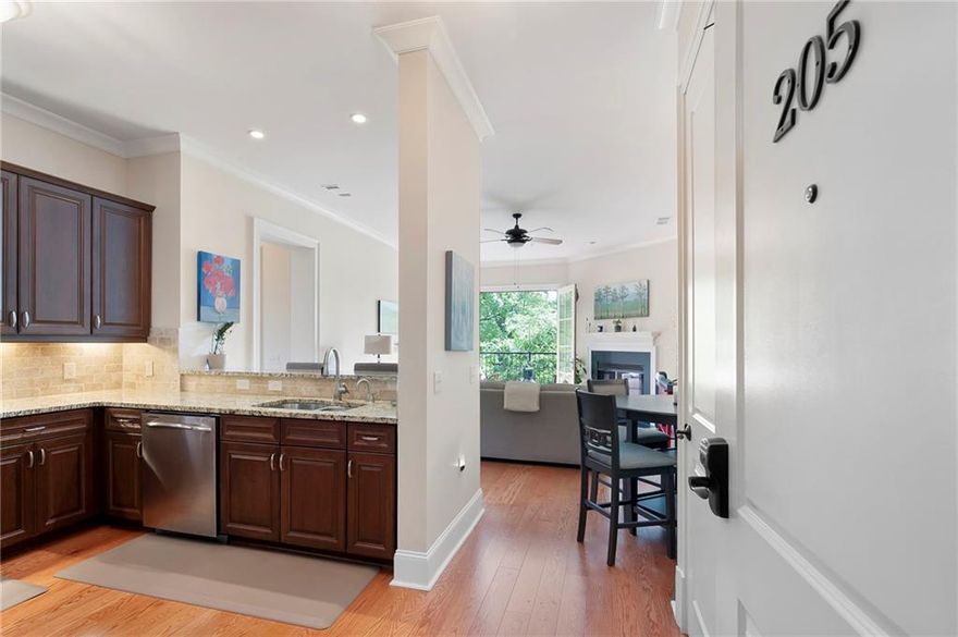 Do not miss out on this corner unit in in Historic Marietta's Washington Avenue Commons. Walking distance to vibrant Marietta Square and all of the fine dining, entertainment, concerts and local artistry that it offers. Corner unit offers fabulous views of Kennestone Hospital skyline and the Marietta National Cemetary. As soon as you enter, you'll be captivated by the stunning view through the double doors leading to the balcony. The 10-foot ceilings and 8-foot solid wood doors enhance the sense of openness, creating an airy, expansive feel throughout the space. Spacious bedrooms each with private en suite access. A cozy corner fireplace adds warmth and charm to the open living area.  Kitchen has stainless appliances, Granite countertops, lots of cabinetry, instant boiling water faucet and a breakfast bar that comfortably seats 3+. Take your entertaining to the next level on the rooftop, which offers both indoor and outdoor spaces, beautiful view of Kennesaw Mountain, and plenty of room for gatherings and events. Covered parking and plenty of space for guests. HOA covers gas, water, trash, termite and pest control, exterior maintenance and reserve fund.