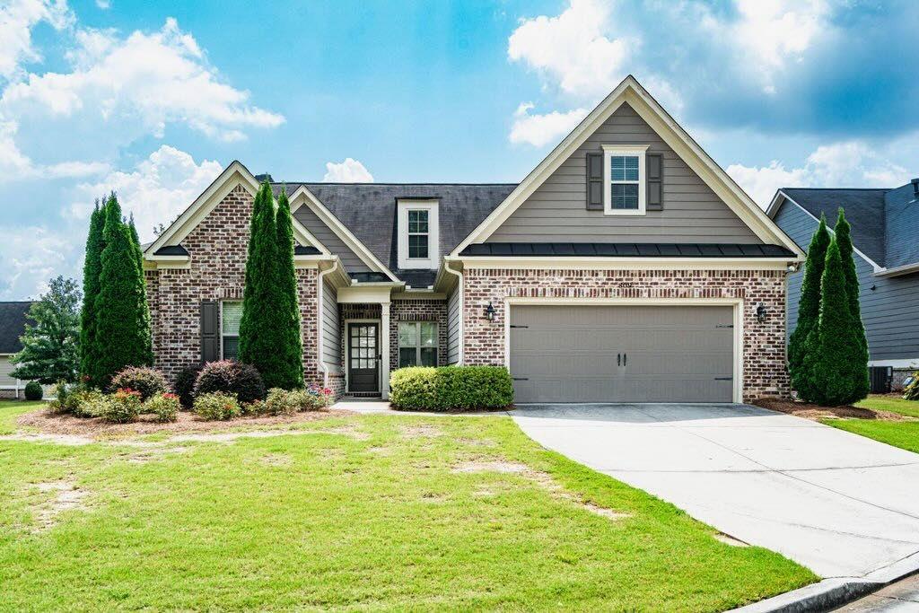 Gorgeous 4-Bedroom Home in Sought-After 55+ Community
Welcome to this stunning 4 bedroom, 3.5 bath home located in the desirable Lake Bridge active adult community. Designed for comfort and style, this residence offers a spacious open floor plan with hardwood floors throughout the main living areas.
The formal dining room, complete with a butler’s hallway, flows seamlessly into the gourmet kitchen featuring granite countertops, a large center island with sink, stainless steel appliances, under-cabinet lighting, and a bright breakfast area. The inviting family room boasts a brick fireplace flanked by custom built-in bookshelves.
The main-level owner’s suite features a tray ceiling and spa-like bath with dual vanities, a soaking tub, and a tiled shower with bench seating. Two additional bedrooms on the main floor share a full bath, while a convenient powder room is perfect for guests. Upstairs, you’ll find a private 4th bedroom with a full bath plus a spacious 12’ x 25’ unfinished room ideal for storage or future expansion.
Step outside to the covered rear porch and patio overlooking the private, fenced backyard with beautiful landscaping—perfect for relaxing or entertaining.
Enjoy low-maintenance living with landscape care included in the HOA fee. Community amenities feature an 8-acre park, pond, walking trails, and gazebo. Conveniently located near the East-West Connector and I-285, you’ll have easy access to Vinings, Smyrna, and Marietta Square.
This home combines modern comfort, thoughtful design, and an unbeatable location—don’t miss your chance to make it yours!