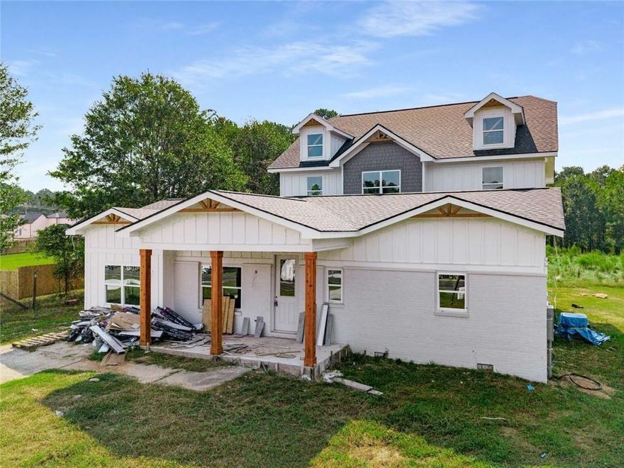 Welcome to 518 Hoke O’Kelly Mill Rd — a stunning new luxury residence in Loganville, move-in ready in November! This exceptional 4-bedroom, 3-bath home blends elegant design with modern convenience, showcasing premium finishes and meticulous craftsmanship throughout. The gourmet kitchen is a true centerpiece open concept to the vast living space. This area boasts quartz countertops, white shaker cabinetry, a stylish herringbone backsplash, a dramatic waterfall island, pot filler. The walk-in pantry is the envy of the best chefs. A built-in wine cooler—ideal for hosting with ease. On the main level, you’ll find a private guest suite, a full bath, and a private flex room perfect for an office, hobby room, fitness room, playroom, or media space. Additional highlights include a convenient mudroom and dual living spaces—each featuring a sleek electric fireplace. Smart switches and voice-controlled lighting add a layer of comfort and sophistication to daily life. Upstairs, the luxurious primary suite offers a peaceful retreat complete with its own fireplace, dual walk-in closets, and a spa-inspired bath featuring a soaking tub, frameless glass shower, and floor-to-ceiling tile. Step outside to enjoy a spacious rear deck, a covered front porch, and the potential for both front and rear irrigation systems. A 3-car garage with rear entry is pleasingly removed from the front elevation. Thoughtfully designed for luxury, comfort, and connection, this new construction home delivers the perfect balance of elegance and everyday ease—without compromise.